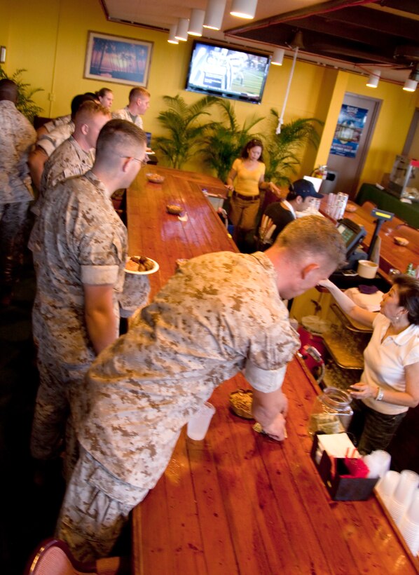 CAMP H.M. SMITH, Hawaii - U.S. Marine Corps Forces, Pacific Headquarters Battalion Marines order drinks and food during a Professional Military Education class Sept. 25, at the Sunset Lanai. The PME was held by MarForPac Sgt. Maj. James Futrell, sergeant major, MarForPac, to talk with Marines about the Marine Corps, current efforts, and answered questions at the end. Futrell used the PME as a orientation to speak with Marines since assuming command roughly two months ago. (Official U.S. Marine Corps photo by Cpl. Achilles Tsantarliotis)(Released)