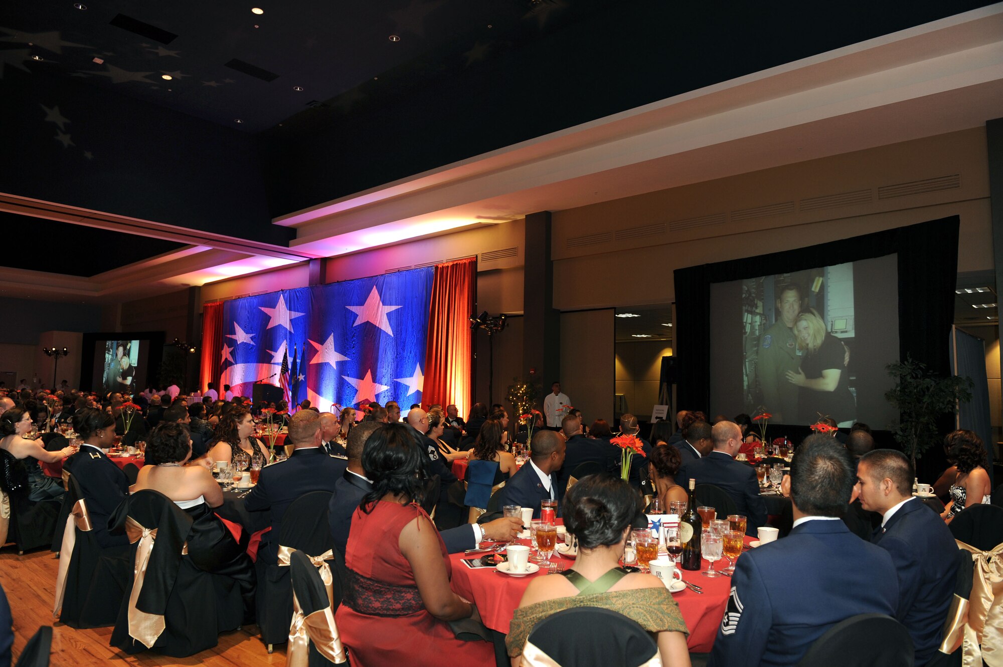 During the 62nd Air Force birthday celebration, many people from the Desert Lightning community gathered to reflect on today’s mission by watching video clips of recently deployed Davis-Monthan military members. Video footage was produced by the 355th Fighter Wing Public Affairs office. The ball was held at the University of Arizona in the Grand Ballroom Sept. 19, 2009. (U.S. Air Force Photo/Staff Sgt. Valerie Smith)

