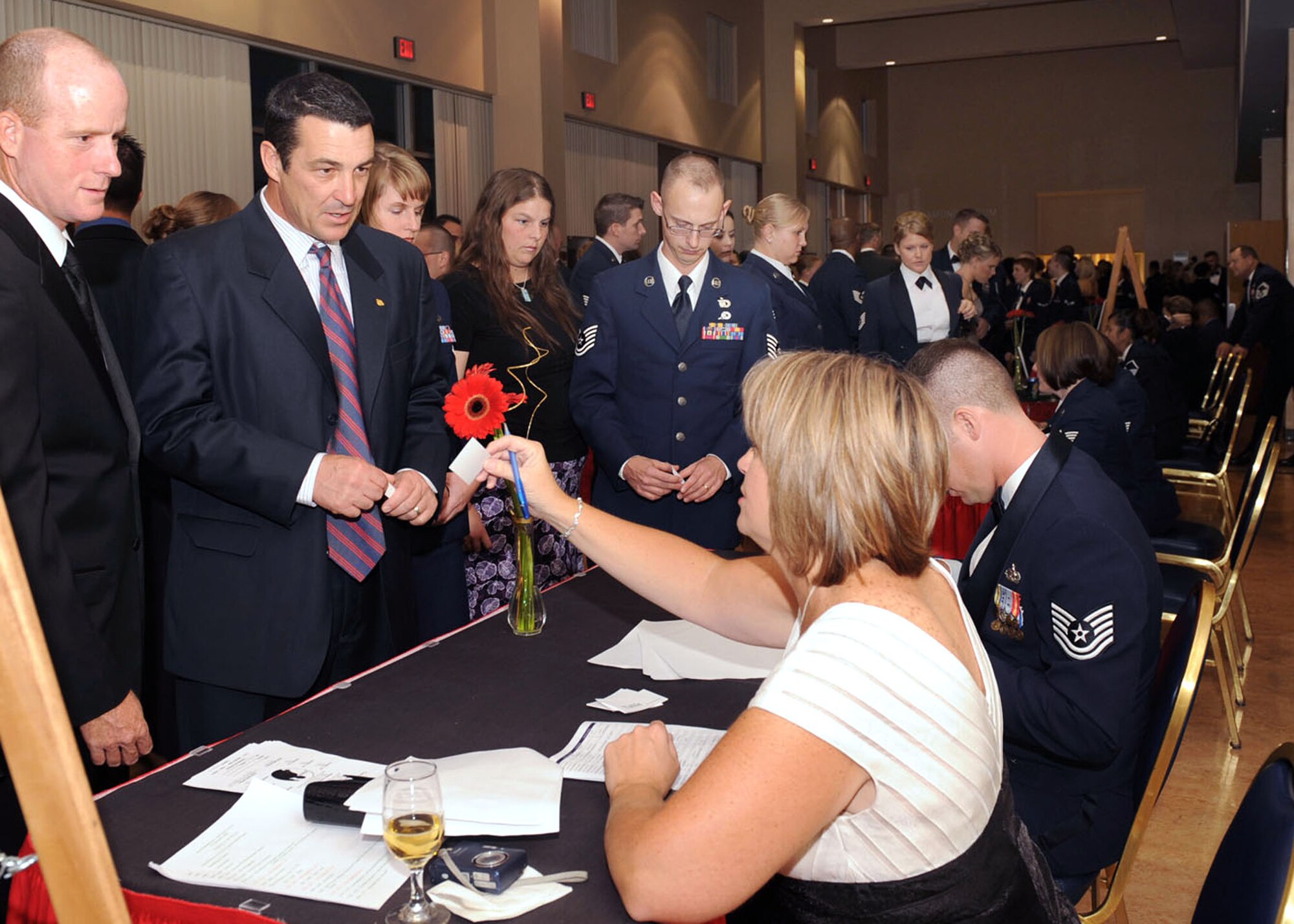 Mrs. Heike Smith, 355th Fighter Wing chief of protocol, distributes tickets to guests for the Air Force Ball, Sept. 19. The Air Force ball was held in celebration of the Air Force's 62nd birthday at the University of Arizona in the Grand Ballroom. (U.S. Air Force photo/Staff Sgt. Valerie Smith)