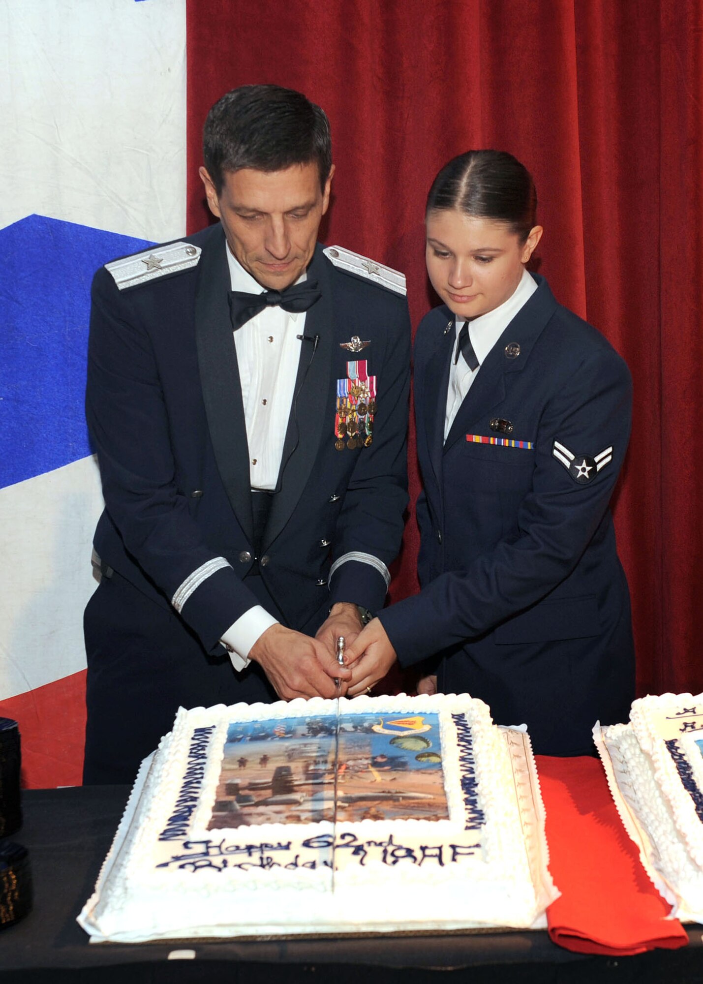 Brig. Gen. Paul Johnson, 355th Fighter Wing commander, along with Airman 1st Class Michelle Carron, 355th Operation Support Squadron, cut the cake at the Air Force Ball, Sept. 19. The Air Force Ball was held at the University of Arizona in the Grand Ballroom in celebration of the Air Force's 62nd birthday. (U.S. Air Force photo/Staff Sgt. Valerie Smith)