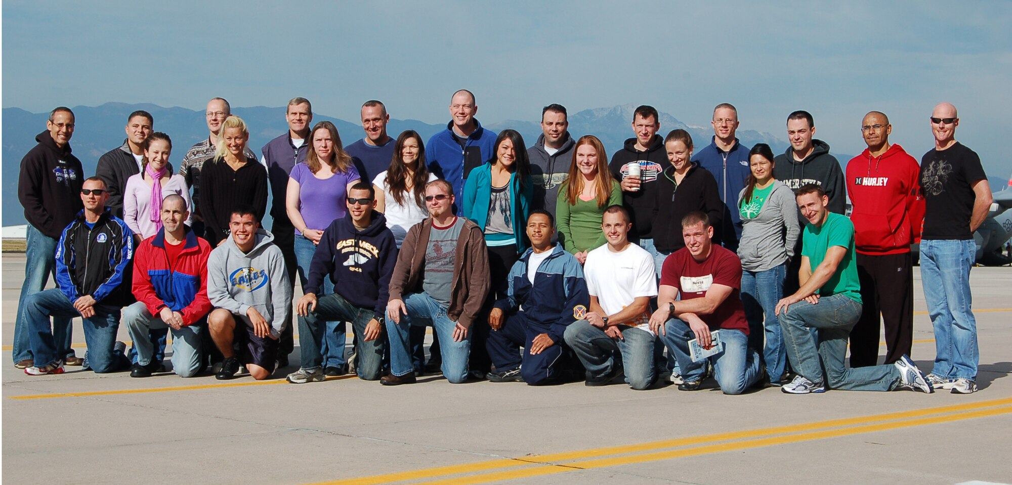 Local Airmen pose for a photograph before boarding a plane on the Peterson flight line Sept. 17 to participate in the Air Force Marathon in Ohio. Forty-five Airmen from installations across the Front Range traveled to Wright Patterson Air Force Base near Dayton, Ohio, for the race Sept. 19. (Air Force photo by Thea Skinner)