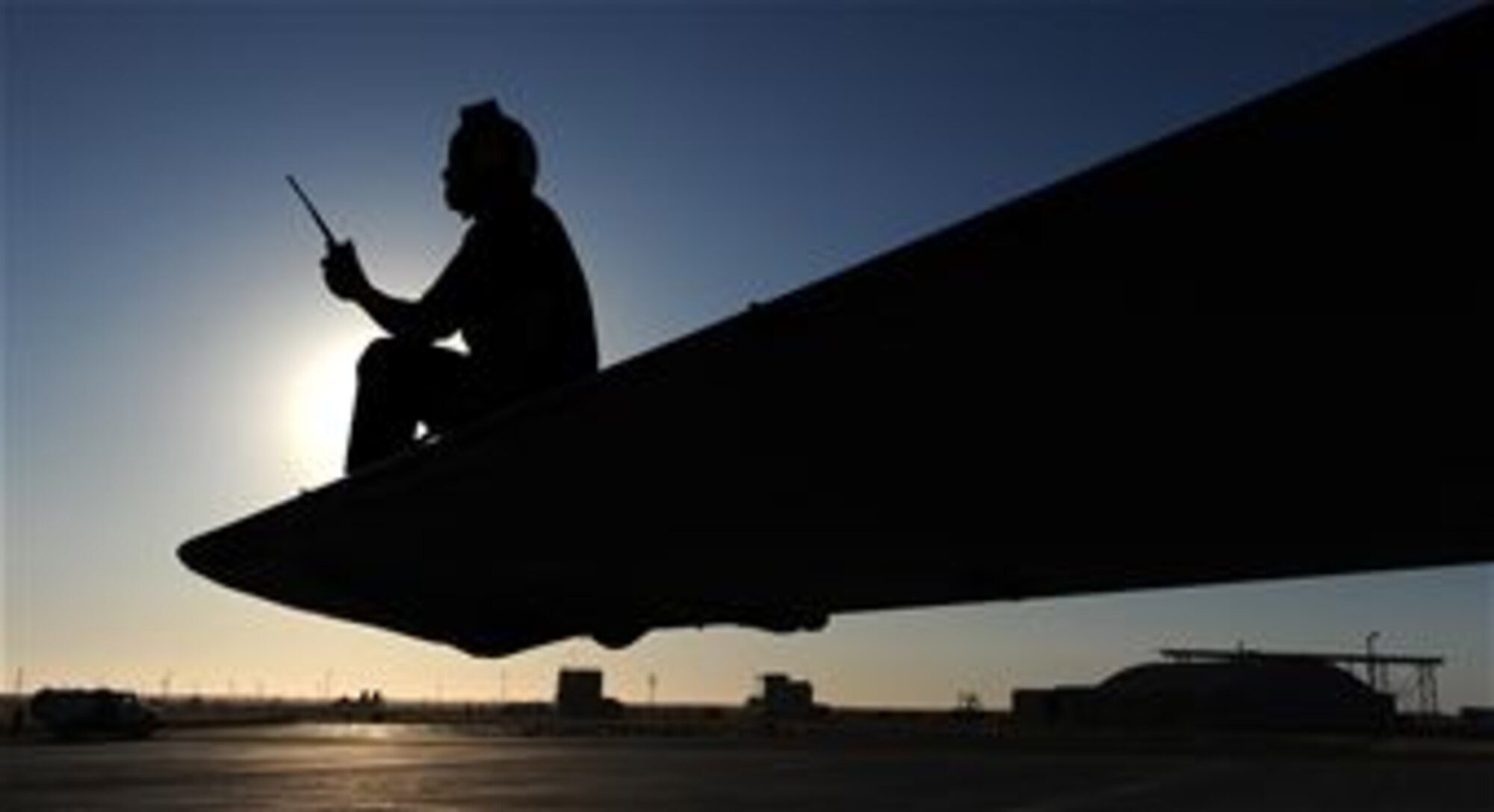 Seaman Apprentice Adan Michels, a plane captain with Tactical Electronic Attack Squadron 137 at Whidbey Island Naval Air Station, Wash., radios back to his shop during a pre-flight inspection on an EA-6B Prowler Sept. 24, 2009, during Gunfighter Flag at Mountain Home Air Force Base, Idaho.  The EA-6B Prowlers participated as friendly "blue air forces" during the exercise.  Gunfighter Flag, which ran from Sept. 14 through 24, was Mountain Home?s first large-scale, multi-national exercise which brought more than 450 personnel from the U.S. Air Force, U.S. Navy and Canadian air force to the base.  (U.S. Air Force photo/Airman 1st Class Debbie Lockhart)