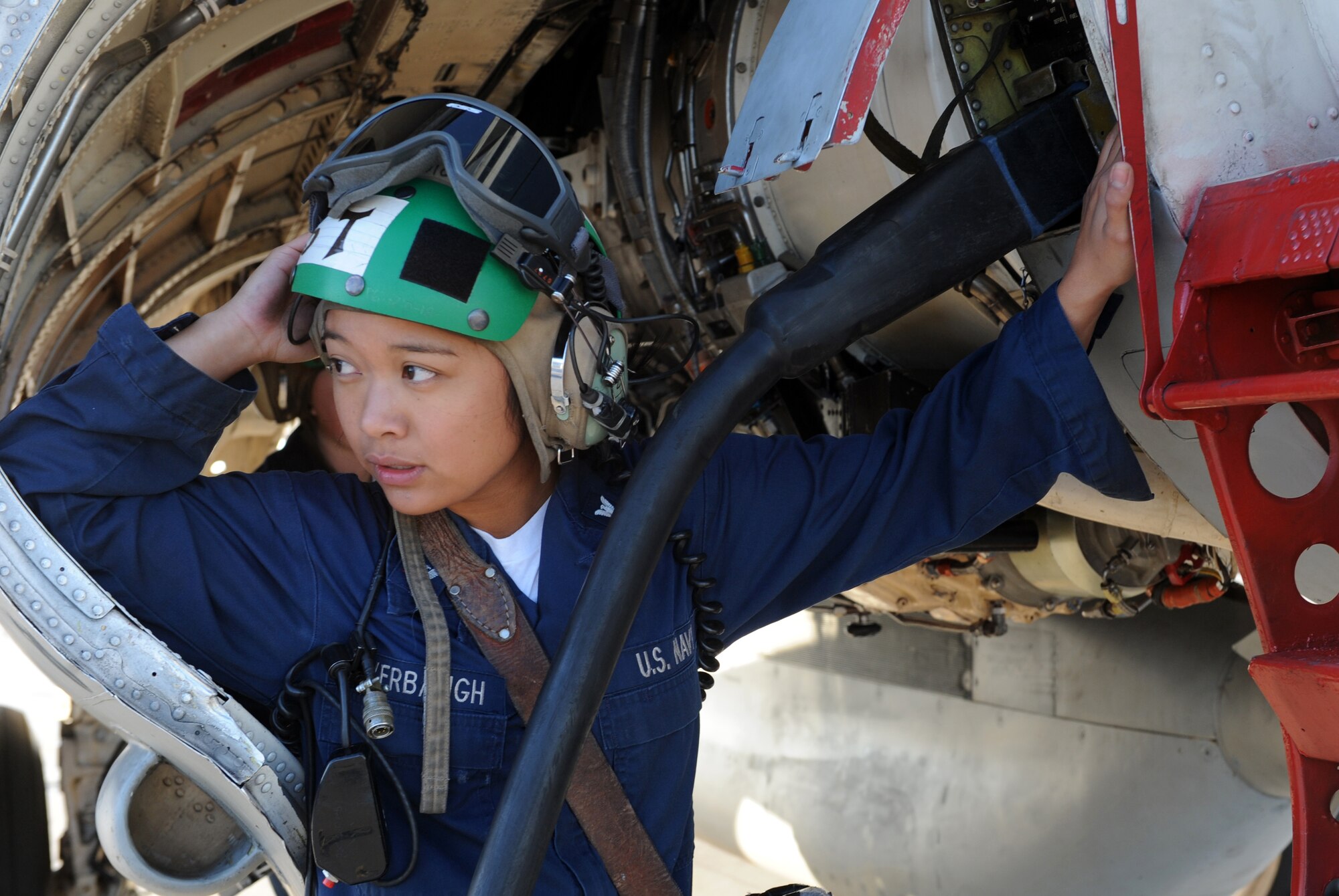 Petty Officer 3rd Class Melinda Overbaugh, an avionics technician 3rd class from Tactical Electronic Attack Squadron 137 at Whidbey Island Naval Air Station, Wash., connects power to an EA-6B Prowler Sept. 24, 2009, during Gunfighter Flag. The EA-6B Prowlers participated as friendly "blue air forces" during the exercise.  Gunfighter Flag, which ran from Sept. 14 through 24, was Mountain Home?s first large-scale, multi-national exercise which brought more than 450 personnel from the U.S. Air Force, U.S. Navy and Canadian air force to the base.  (U.S. Air Force photo/Airman 1st Class Debbie Lockhart)