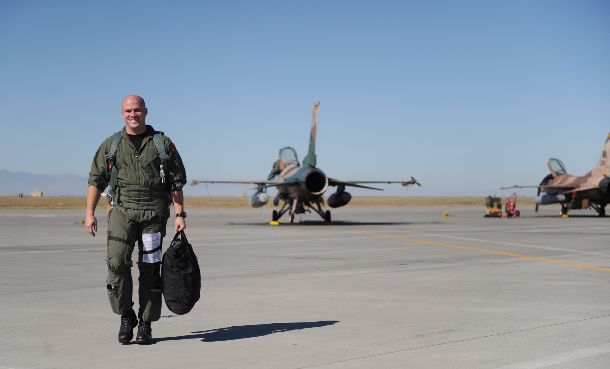Capt. Robert Stimpson, a 64th Aggressor Squadron pilot from Nellis Air Force Base, Nev., heads for base operations at Mountain Home AFB, Idaho, after flying a training mission Sept. 23 during Gunfighter Flag.  With a mission to know, teach and replicate any threat friendly forces may face, pilots from the 64th AGS flying F-16 Fighting Falcons represented enemy aircrews as ?red air force? participants during the exercise.  Gunfighter Flag, which ran from Sept. 14 through 24, was Mountain Home?s first large-scale, multi-national exercise which brought more than 450 personnel from the U.S. Air Force, U.S. Navy and Canadian air force to the base.  (U.S. Air Force photo/Airman 1st Class Renishia Richardson)