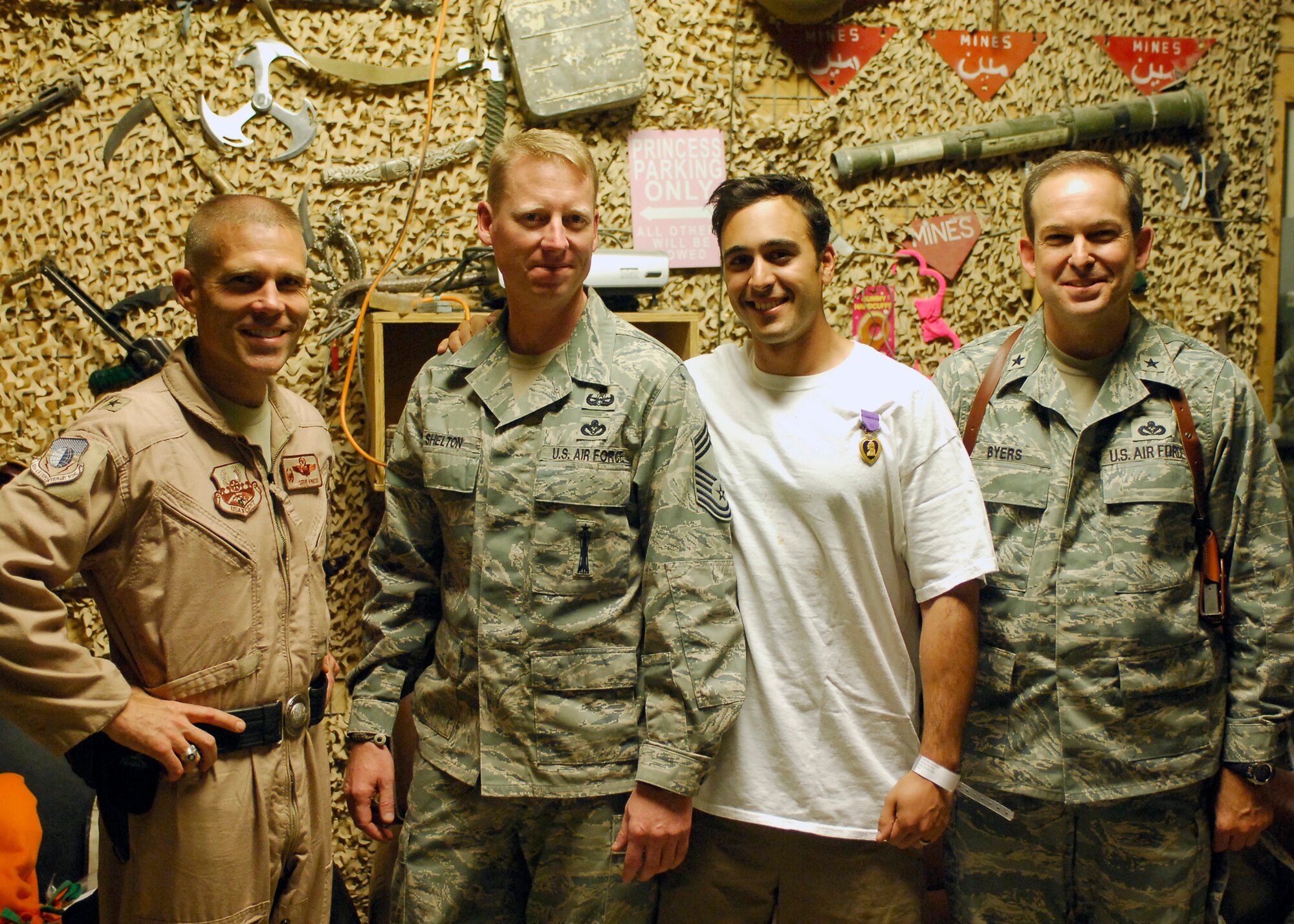 Tech. Sgt. Richard Gibbons (center right), 140th Civil Engineering Explosive Ordnance Disposal Flight, is awarded a Purple Heart medal Sept. 19, 2009, at Bagram Air Base, Afghanistan. His vehicle was hit by a rocket-propelled grenade while on a mounted patrol in Afghanistan earlier in the week. (Courtesy photo)