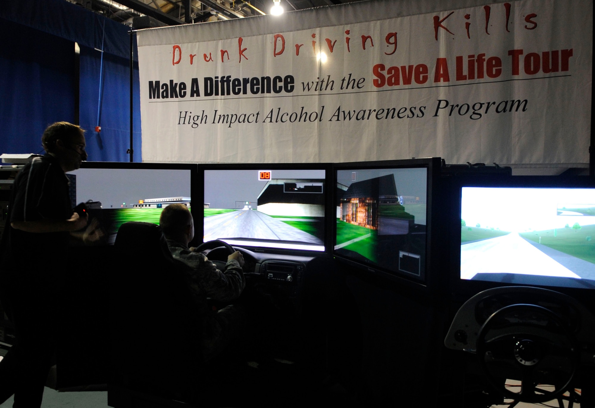 LANGLEY AIR FORCE BASE, Va. -- Staff Sgt. Ricky Barberree, 1st Fighter Wing Safety Office, receives guidance from Cejay Rich, Save-a-Life Tour member, while driving the drunk-driver simulator here Sept. 25. Each year, the Save-a-Life Tour visits Langley to increase awareness of drunk driving and promote responsibility to Airmen. (U.S. Air Force Photo/Senior Airman Dana Hill)