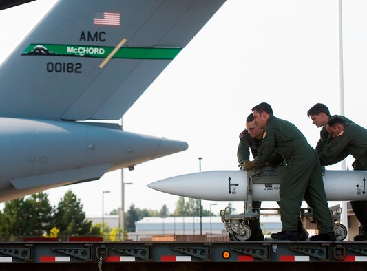 Loadmasters from the 4th Airlift Squadron load a training device onto a C-17 Globemaster III at McChord Air Force Base, Wash., recently during mission readiness training for the units Prime Nuclear Airlift Force mission. (U.S. Air Force Photo/Abner Guzman) 