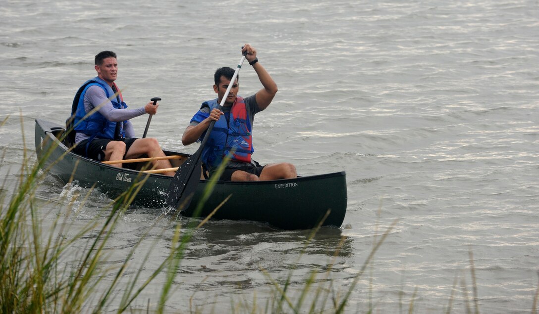 LANGLEY AIR FORCE BASE, Va. – Second Lt. Jethro Sadorra, 1st Civil Engineer Squadron, and teammate 1st Lt. Brandon Bryan, 1st Logistics Readiness Squadron, row their way to the finish line during a triathlon here Sept 25. Lieutenants Sadorra and Bryan came in first place with a time of 51 minutes and 38 seconds. (U.S. Air Force Photo/Senior Airman Dana Hill)