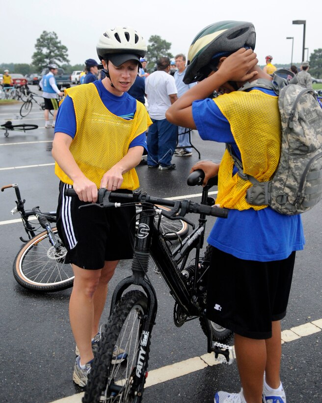 LANGLEY AIR FORCE BASE, Va. -- Second Lt. Yvonne Nollmann, 1st Logistic Readiness Squadron, explains the gear shift on her bicycle to 1st Lt. Lajoyce House, 1st LRS, before competing in a triathlon here Sept. 25.  Lieutenants Nollmann and House finished in 13th place out of the 21 teams that competed in the event. (U.S. Air Force Photo/Senior Airman Dana Hill)
