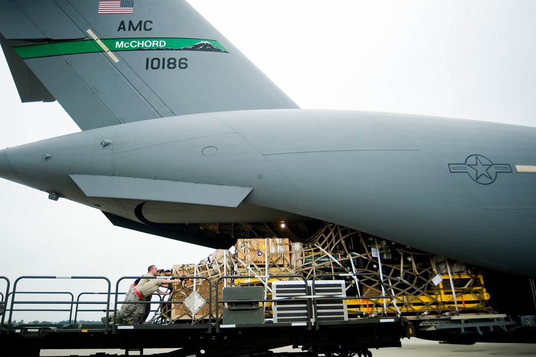 Airmen load cargo onto a C-17 Globemaster III prior to departure for a mission in support of Operation Deep Freeze to Antarctica Sept. 24, 2009, at McChord Air Force Base, Wash. (U.S. Air Force photo/Abner Guzman) 