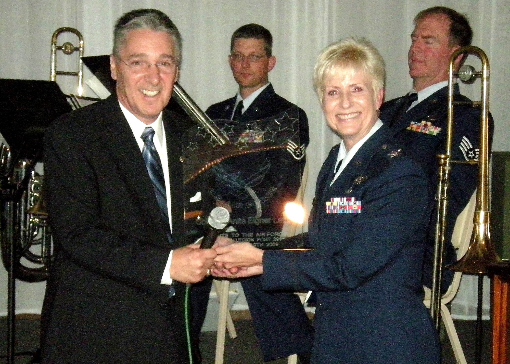 Colonel Anita Latin, 61 st Air Base Wing commander receives a standup award from Bill Dunn, American Legion Post 291 first vice commander, Sept. 19. The colonel received the award for supporting the post's 62nd Anniversary celebration as the guest speaker and for her outstanding commitment to the Air Force.  (Photo by LaGina D. Jackson)