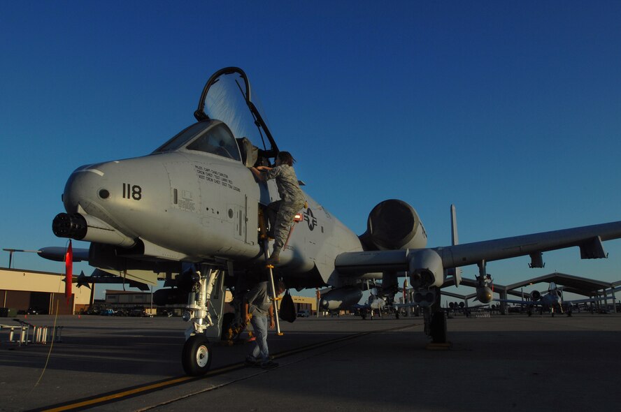 WHITEMAN AIR FORCE BASE, Mo. - Airman Jill Hallandsworth and Larry Rex, 442nd Fighter Wing crew chiefs, make their way into the crew station of an A-10 Thunderbolt II during an early morning pre-flight inspection of the aircraft Sept. 25. Crew chiefs with the 442nd FW maintain a vast fleet of 27 A-10 Aircraft keeping each jet prepared for any mission at a moment's notice. (U.S. Air Force photo/Senior Airman Kenny Holston)  