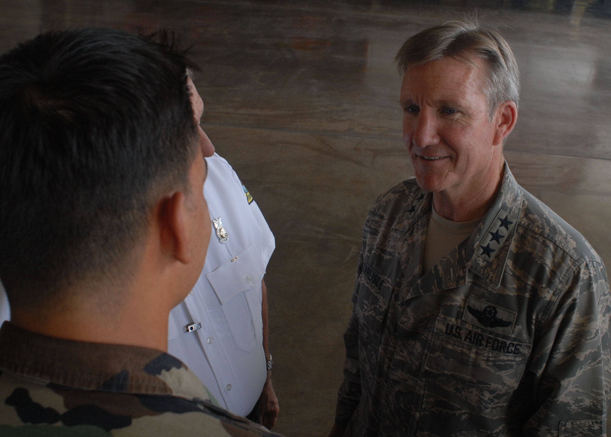 HICKAM AIR FORCE BASE, Hawaii -- Lt. Gen. "Hawk" Carlisle, 13th Air Force commander, speaks to Airman 1st Class Matthew Pires, 15th Civil Engineer Squadron firefighter, during his tour of the 15th Airlift Wing here, Sept. 24. General Carlisle assumed command of the 13th Air Force on Sept. 2. (U.S. Air Force photo/Senior Airman Gustavo Gonzalez)