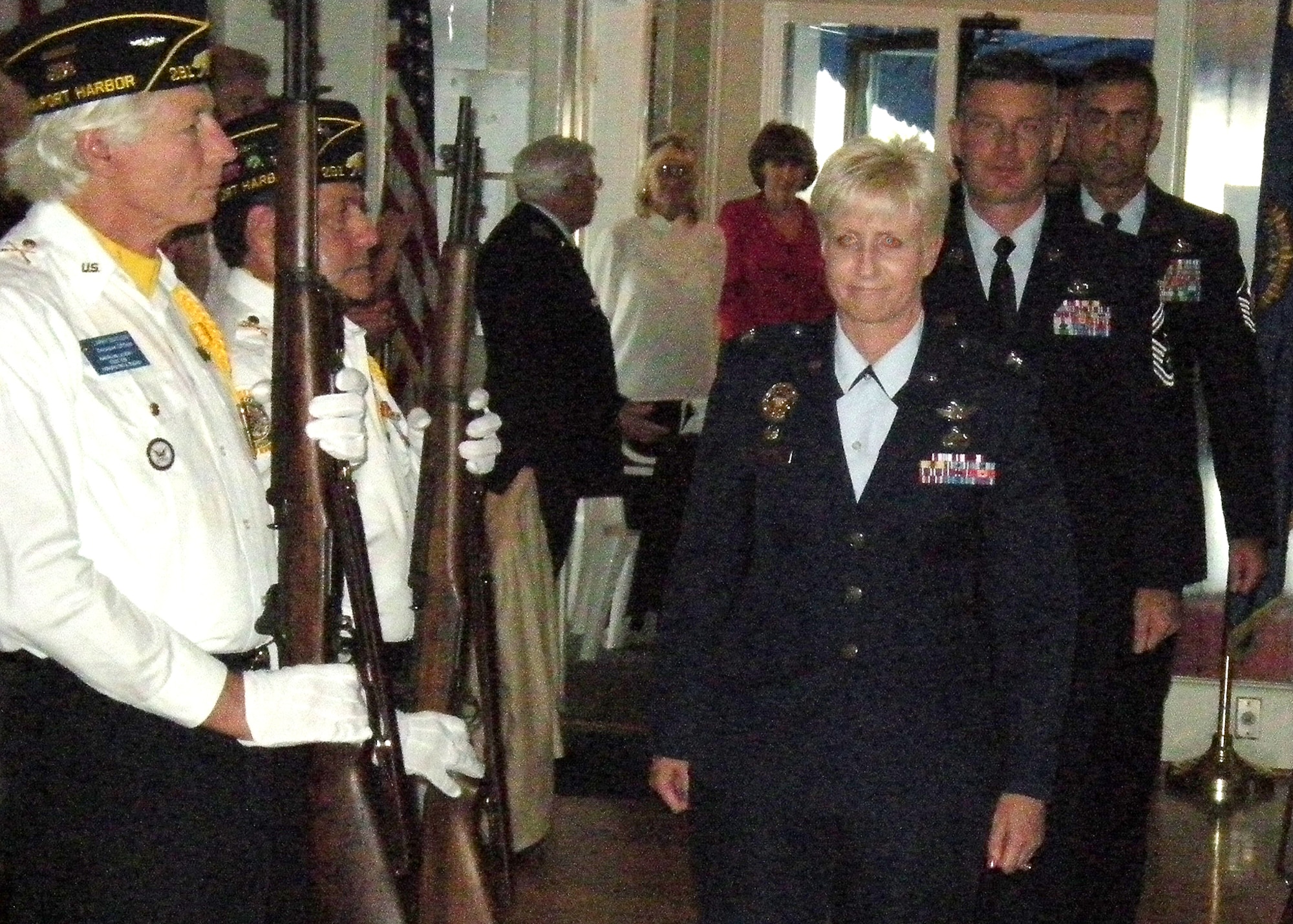Colonel Anita Latin, 61st Air Base Wing commander and Chief Master Sgt. Stephen Ludwig, SMC command chief master sergeant, and other active duty airmen, walk through a rifle squad honor formation during the American Legion Post 291’s Air Force 62nd Anniversary celebration, Sept. 19.  (Photo by LaGina D. Jackson)