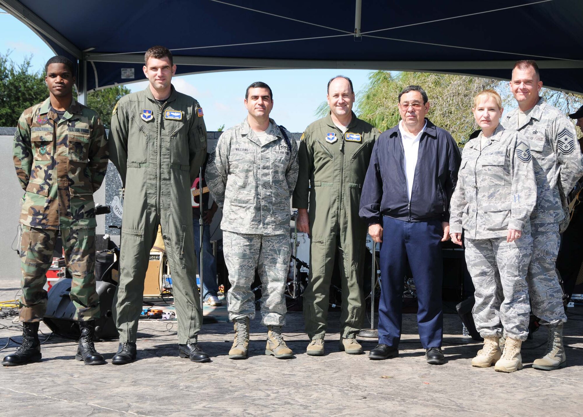 ALTUS AIR FORCE BASE, Okla. - Col. Stuart Shaw, 97th Air Mobility Wing vice commander, coins Senior Airman Marlon Mcilwain, Capt. Jeremy Ponn, Tech. Sgt. Douglas Williams, Harland Fox, Master Sgt. Elizabeth Molloy, and Chief Master Sgt. Eric Molloy Sept. 22 at the Wings of Freedom Park for their outstanding performances during the Unit Compliance Inspection. (U.S. Air Force photo/Senior Airman Marianne E. Lane)
