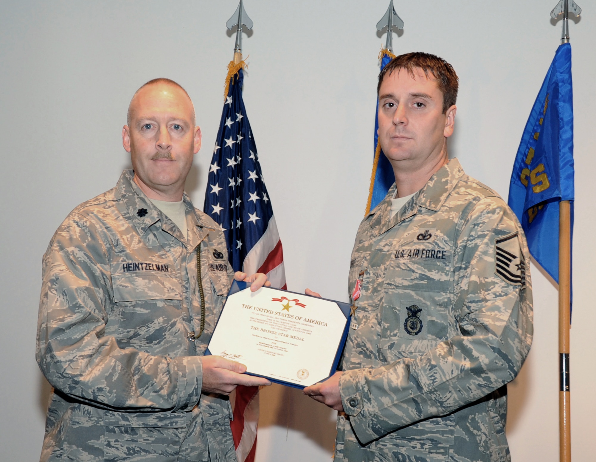 Lt. Col. Timothy Heintzelman, 87th Air Base Wing Security Forces Squadron Commander, presents Tech. Sgt. Christopher Wright with the Bronze Star during a commander’s call on Sept. 17 here. Sergeant Wright led 15 personnel on more than 150 ground combat patrols, logging over 1,000 hours outside the defended base perimeter, while deployed in support of Operation Iraqi Freedom. He and his team neutralized five insurgent cells, eliminated 74 insurgent threats and contributed to the capture of 23 enemy personnel. (U.S. Air Force Photo/Carlos Cintron)
