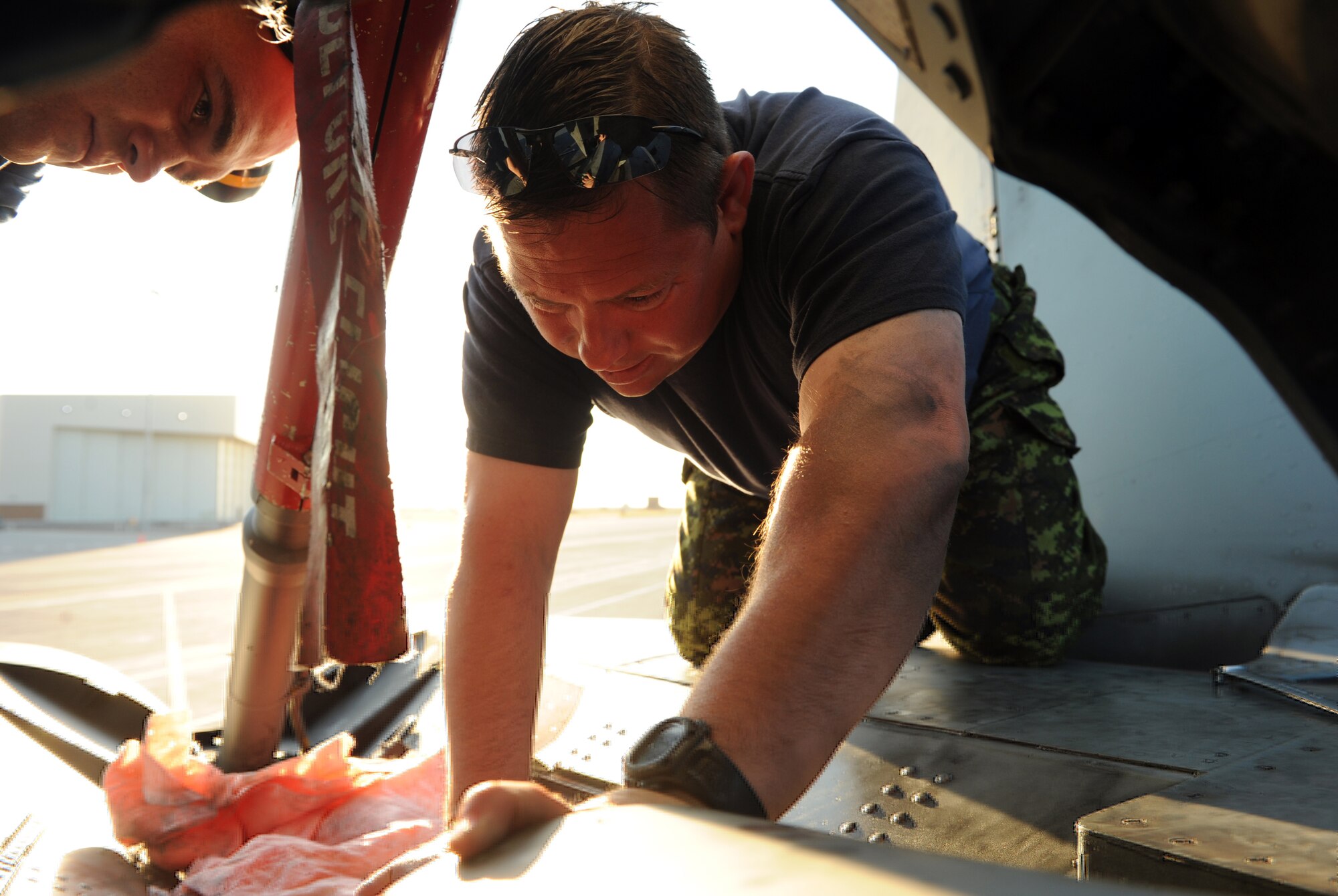 MOUNTAIN HOME AIR FORCE BASE, Idaho -- Master Cpl. Lyndon Locke, 409th Tactical Fighter Squadron aviation technician, fixes a brake panel on a CF-18 Hornet Sept. 25 after Gunfighter Flag. The CF-18 Hornets from the 409th TFS out of Cold Lake, Alberta, Canada, participated as friendly "blue air" forces during the exercise. Gunfighter Flag, which ran from Sept. 14 through 24, was Mountain Home's first ever large-scale, multi-national exercise which brought more than 450 personnel from the U.S. Air Force, U.S. Navy and Canadian air force to Mountain Home. (U.S. Air Force photo by Airman 1st Class Debbie Lockhart)