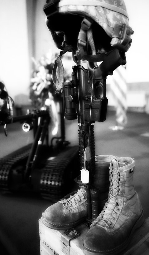 The helmet and dog tags belonging to Staff Sgt. Brian David Berky, 28th Civil Engineer explosive ordnance disposal craftsman, are displayed at his memorial service held on Ellsworth Air Base, S.D., Sept. 24, 2009. Sergeant Berky died Sept. 12 near Bala Baluk, Afghanistan, of wounds inflicted by enemy fire. (U.S. Air Force photo illustration/ Airman 1st Class Adam Grant)