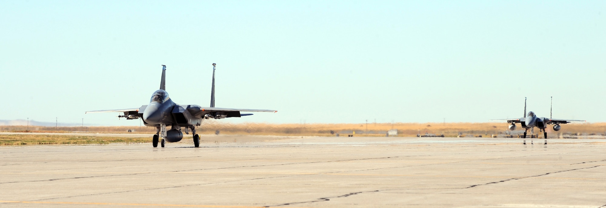 MOUNTAIN HOME AIR FORCE BASE, Idaho -- Two F-15E Strike Eagles from the 389th Fighter Squadron taxi down the runway before taking off on the last day of Gunfighter Flag Sept. 24. Gunfighter Flag, which ran from Sept. 14 through 24, was Mountain Home's first ever large-scale, multi-national exercise which brought more than 450 personnel from the U.S. Air Force, U.S. Navy and Canadian air force to Mountain Home. (U.S. Air Force photo by Airman 1st Class Debbie Lockhart)