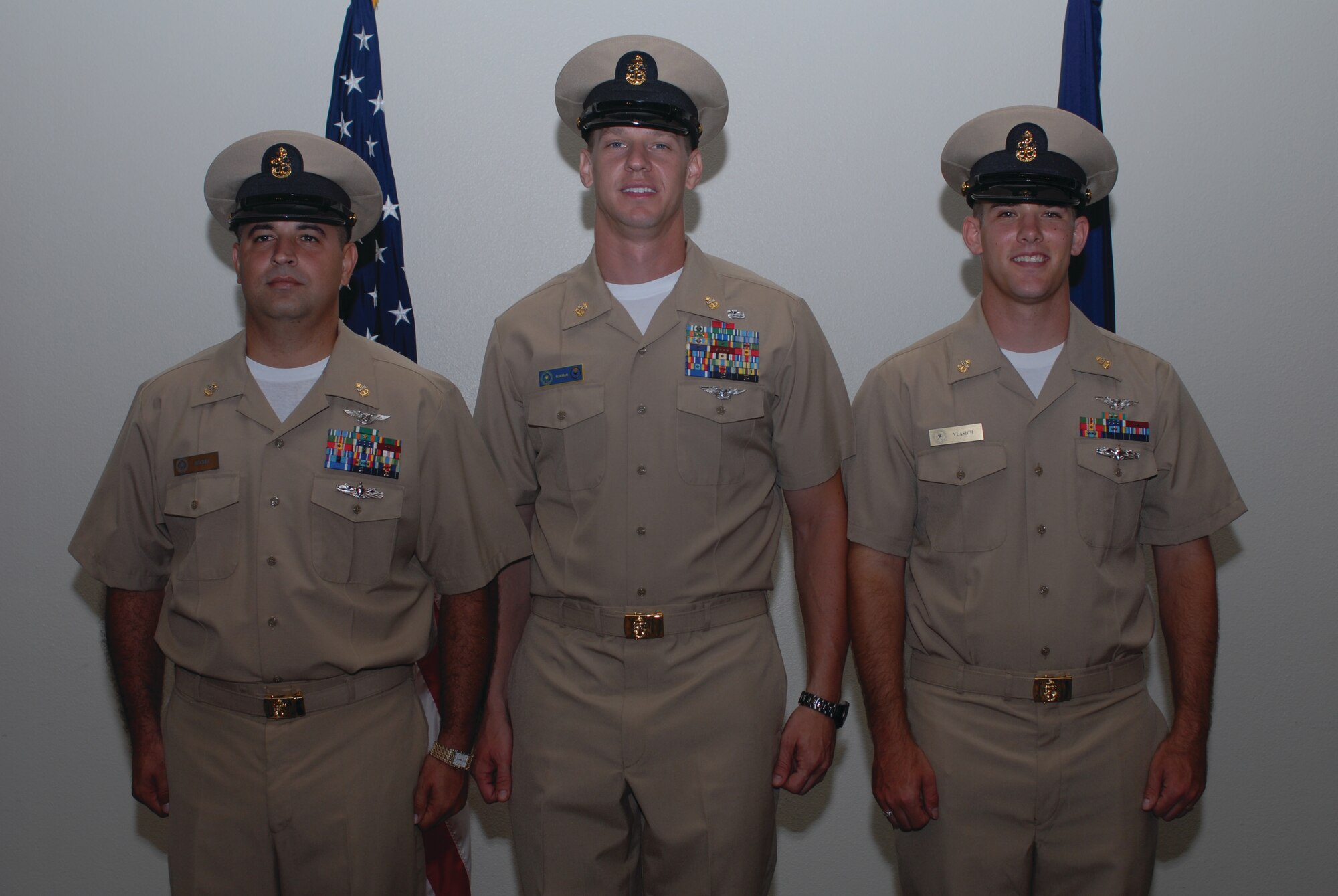Chief Petty Officers Jose Suarez III, 312th Training Squadron, David Norman and Steven Vlasich II, Center for Information Dominance Detachment, pose for a group photo following their promotion ceremony, Sept. 16, at the Event Center. (U.S. Air Force photo by Staff Sgt. Laura R. McFarlane)