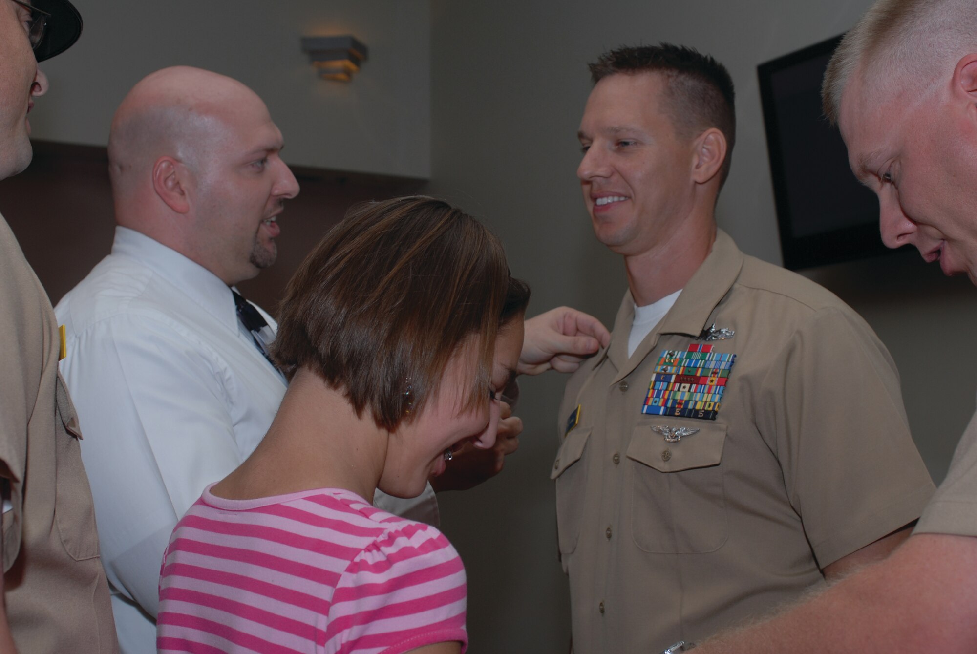 Chief Petty Officer David Norman, Center for Information Dominance Detachment, has his anchors pinned on by his daughter Marcela and friend Ron Anderson during the promotion ceremony, Sept. 16, at the Event Center. (U.S. Air Force photo by Staff Sgt. Laura R. McFarlane)