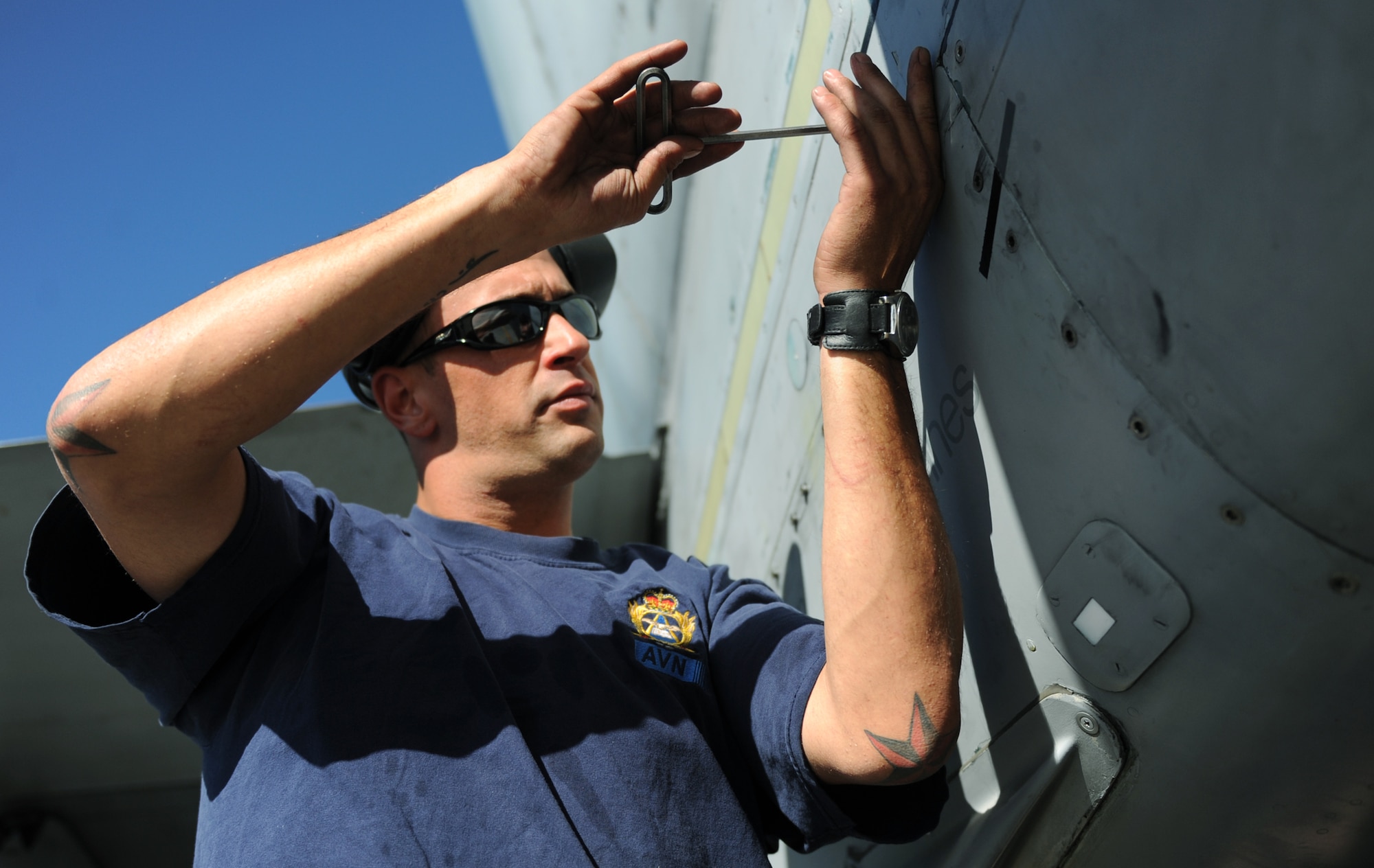 MOUNTAIN HOME AIR FORCE BASE, Idaho-- Master Corporal Jason Porter, 409th Tactical Fighter Squadron aviation systems technician, loosens a bolt on a CF-18 Hornet during Gunfighter Flag Sept. 23. The CF-18 Hornets from the 409th TFS out of Cold Lake, Alberta, Canada, participated as friendly “blue air” forces during the exercise. Gunfighter Flag, which ran from Sept. 14 through 24, was Mountain Home’s first ever large-scale, multi-national exercise which brought more than 450 personnel from the U.S. Air Force, U.S. Navy and Canadian air force to Mountain Home. (U.S. Air Force photo by Airman 1st Class Renishia Richardson) 