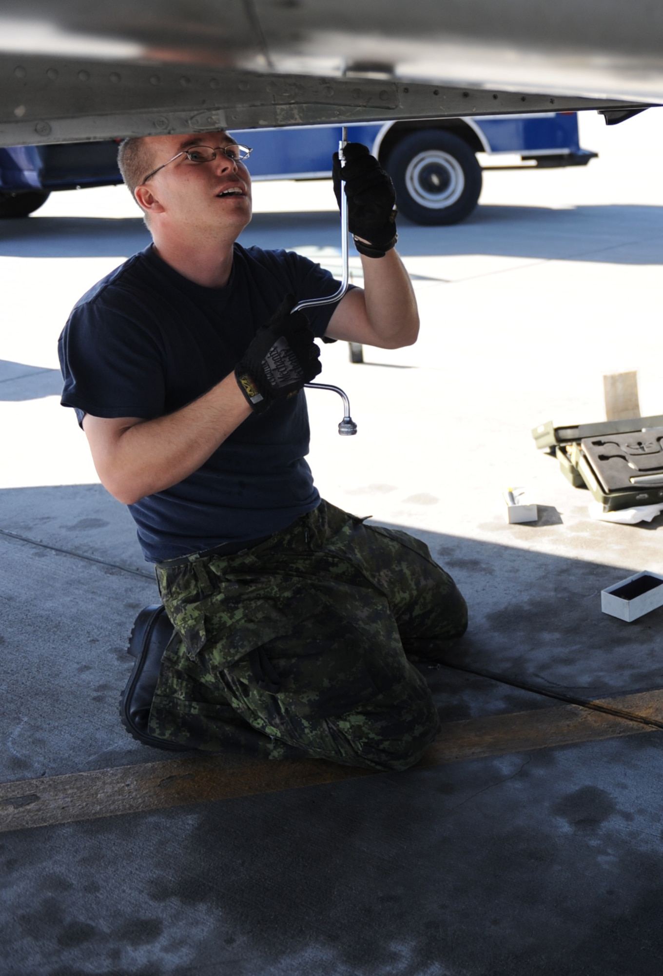 MOUNTAIN HOME AIR FORCE BASE, Idaho -- Private Thomas William, 409th Tactical Fighter Squadron aviation systems technician, loosens a bolt on a CF-18 Hornet during Gunfighter Flag Sept. 23.  The CF-18 Hornets from the 409th TFS out of Cold Lake, Alberta, Canada, participated as friendly “blue air” forces during the exercise. Gunfighter Flag, which ran from Sept. 14 through 24, was Mountain Home’s first ever large-scale, multi-national exercise which brought more than 450 personnel from the U.S. Air Force, U.S. Navy and Canadian air force to Mountain Home. (U.S. Air Force photo by Airman 1st Class Renishia Richardson) 