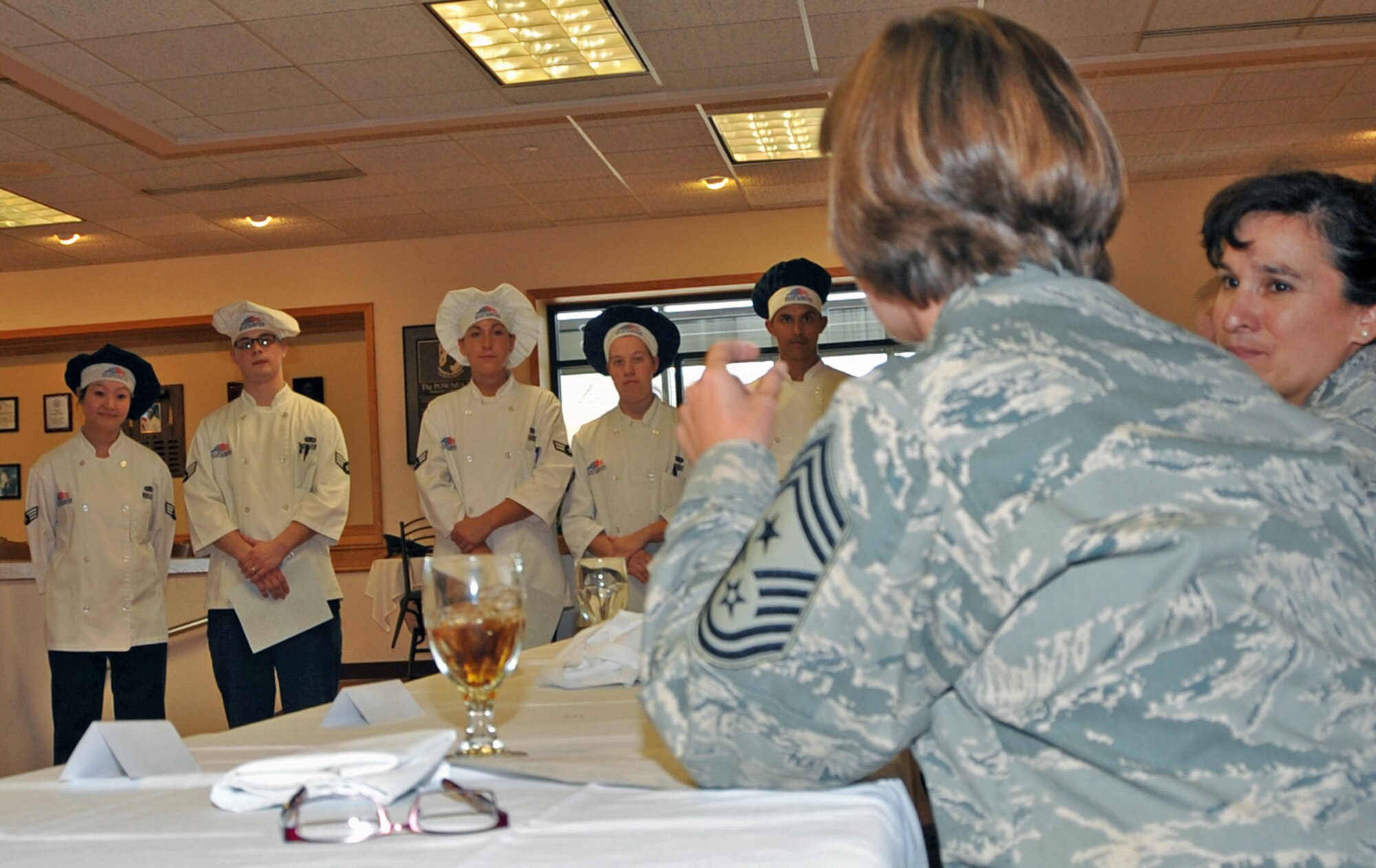 OFFUTT AIR FORCE BASE, Neb. - Chief Master Sgt. Lisa Sirois speaks to the chefs who participated in the Iron Chef Competition held at the King Dining Facility Sept. 23. The three teams of chefs prepared appetizers, a main course and desert dishes for judges to score. Each team was awarded a day off for their participation and the winning team was awarded 2 days off. U.S. Air Force photo by Jeff W. Gates.