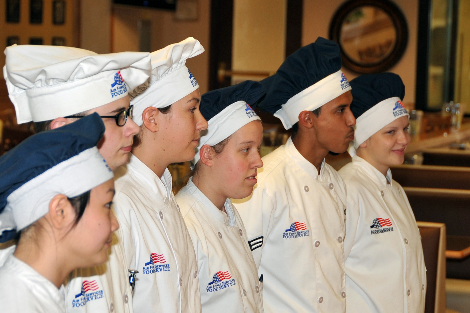 OFFUTT AIR FORCE BASE, Neb. - Chefs listen to judges critique their meals in the Iron Chef Competition held at the King Dining Facility Sept. 23. The three teams of chefs prepared appetizers, a main course and desert dishes for judges to score. Each team was awarded a day off for their participation and the winning team was awarded two days off. U.S. Air Force photo by Jeff W. Gates.