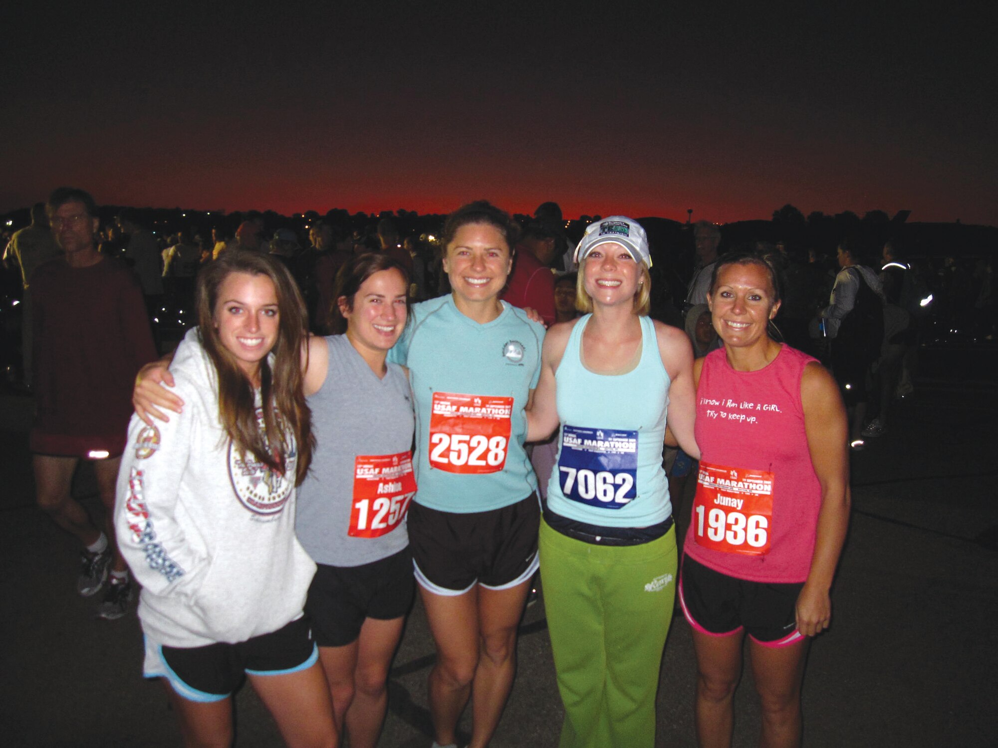 Left to right, Airman 1st Class Jennifer Arnette, 311th  Training Squadron, Airman 1st Class Ashlee Laing, 314th  Training Squadron,  Airman 1st Class Marisa Scheetz, 311 TRS, Staff Sgt.  Lesley Bastura, 314 TRS, Staff Sgt.  Junay Skinner, 311 TRS, all from Presidio of Monterey, Calif, pose for a group shot before the start of the marathon, Sept. 19, at Wright-Patterson AFB, Ohio. (U.S. Air Force photo by Airman 1st Class Derek Richardson.)