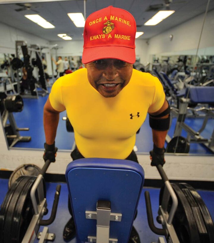 Sixty-two year-old Johnny Martin performs a set of shrugs, which work the trapezius, or traps, muscles.