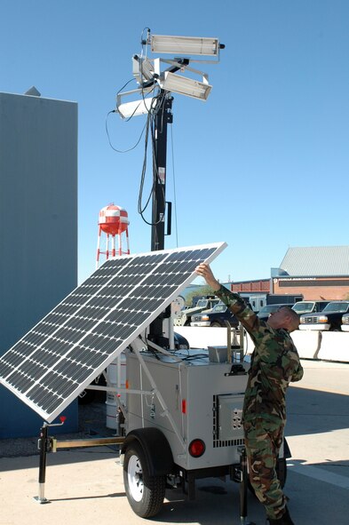 Tech. Sgt. Martin Buelow, a power support systems mechanic with the 162nd Fighter Wing’s Aerospace Ground Equipment shop, sets up a mobile solar flood light near the flightline at Tucson International Airport, Sept. 24. Solar-powered lighting will reduce the wing’s annual energy consumption saving money and the environment. (Air National Guard photo by Maj. Gabe Johnson)