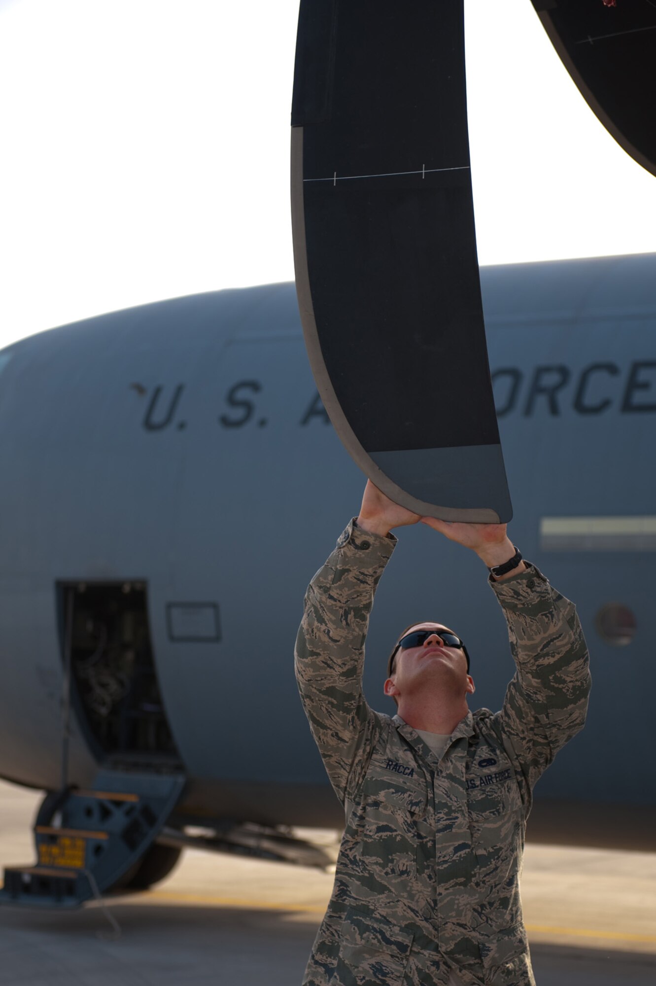 Senior Airman Tyler Racca, 746th Expeditionary Aircraft Maintenance Unit crew chief, inspects a C-130J for damage to ensure serviceability, Sept. 22, in Southwest Asia. The 746 EAMU supports deployed C-130Js which provide intra-theater combat airlift support throughout Southwest Asia. Airman Racca is deployed from Keesler Air Force Base, Miss., in support of Operations Iraqi and Enduring Freedom. (U.S. Air Force photo/Staff Sgt. Robert Barney) 