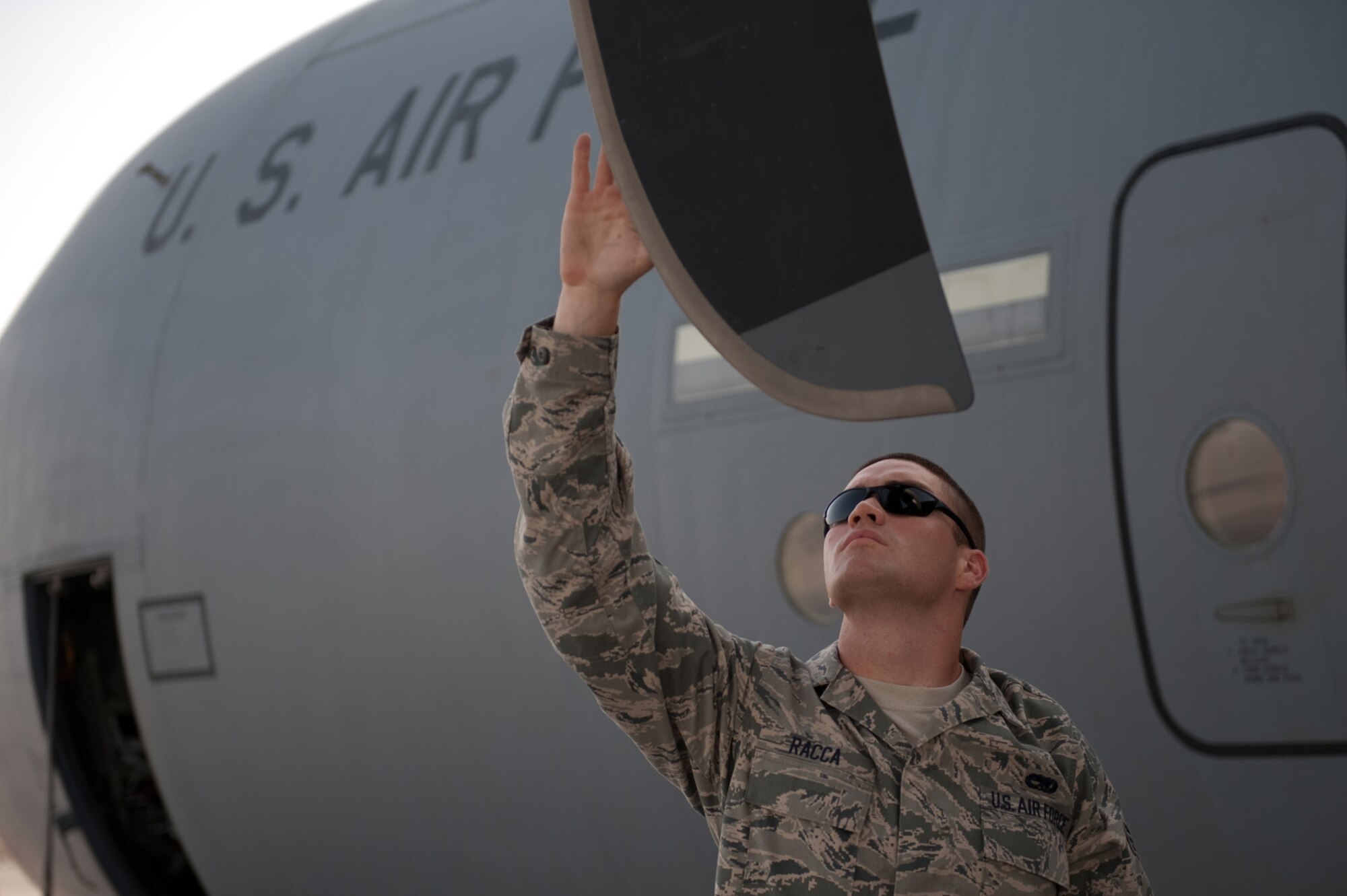 Senior Airman Tyler Racca, 746th Expeditionary Aircraft Maintenance Unit crew chief, inspects a C-130J for damage to ensure serviceability, Sept. 22, in Southwest Asia. The 746 EAMU supports deployed C-130Js which provide intra-theater combat airlift support throughout Southwest Asia. Airman Racca is deployed from Keesler Air Force Base, Miss., in support of Operations Iraqi and Enduring Freedom. (U.S. Air Force photo/Staff Sgt. Robert Barney) 