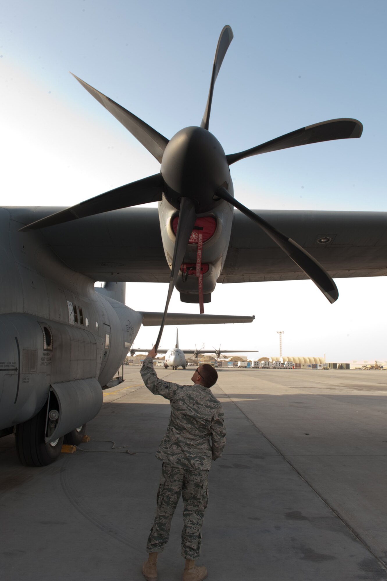 Senior Airman Tyler Racca, 746th Expeditionary Aircraft Maintenance Unit crew chief, inspects a C-130J for damage to ensure serviceability, Sept. 22, in Southwest Asia. The 746 EAMU supports deployed C-130Js which provide intra-theater combat airlift support throughout Southwest Asia. Airman Racca is deployed from Keesler Air Force Base, Miss., in support of Operations Iraqi and Enduring Freedom. (U.S. Air Force photo/Staff Sgt. Robert Barney) 
