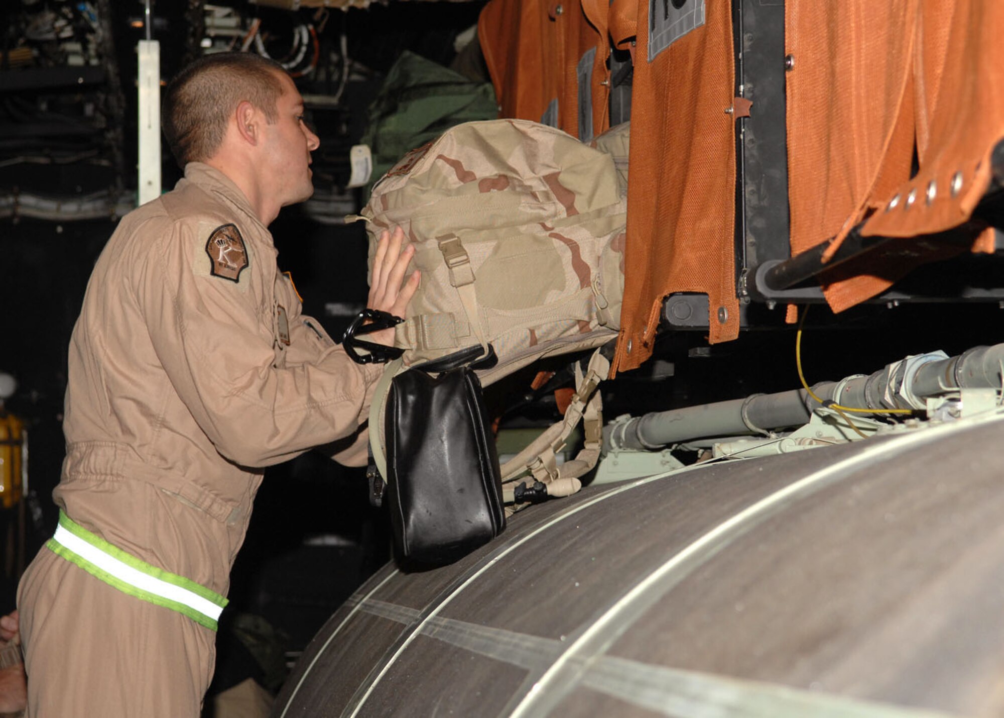 Staff Sgt. Christopher Bageant, 79th Rescue Squadron, stows his personal bag on the HC- 130 P aircraft Sept. 23 prior to deploying to the Horn of Africa. (U.S. Air Force photo/Airman Jerilyn Quintanilla)
