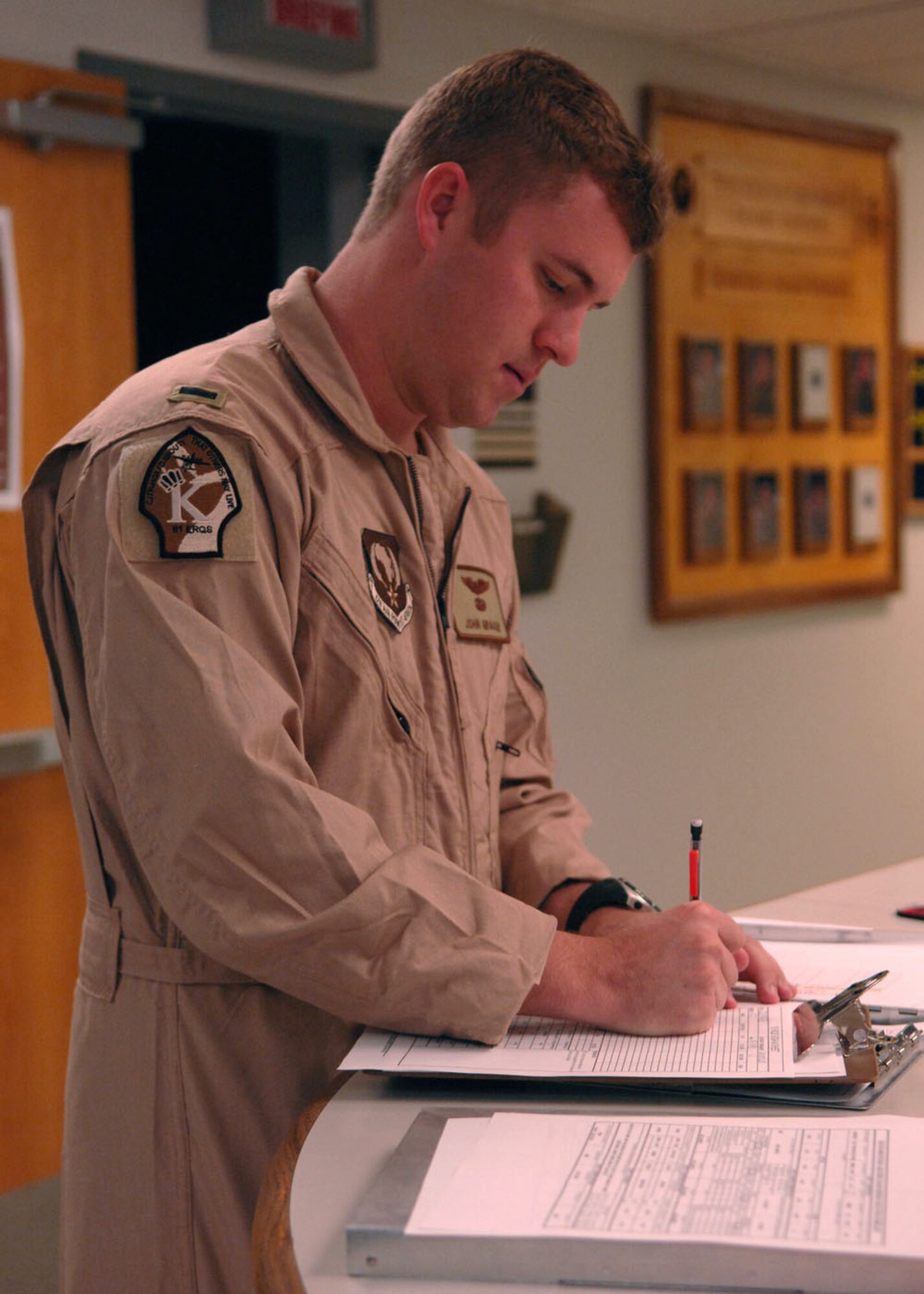 1st Lt. Kris Putnam, 79th Rescue Squadron, signs deployment paperwork Sept. 23. Lieutenant Putnam, along with 14 other rescue squadron personnel deployed to the Horn of Africa. The 79th Rescue Squadron will support U.S. Africa Command with various personnel recovery operations. (U.S. Air Force photo/Airman Jerilyn Quintanilla)