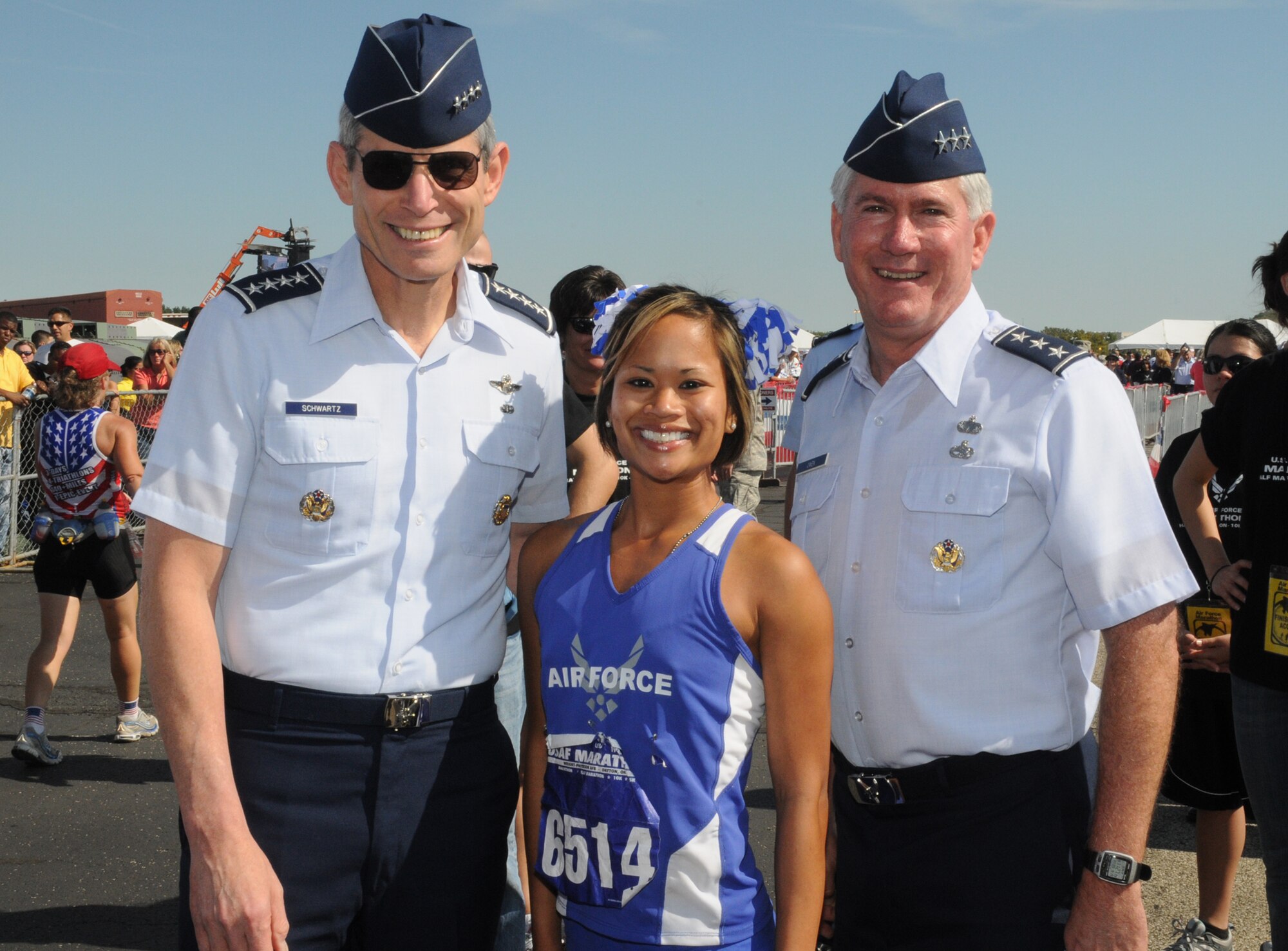 Air Force Chief of Staff Gen. Norton Schwartz and Aeronautical Systems Center commander, Lt. Gen. Tom Owen join Staff Sgt. Trasy Rincan at the finish line for the U.S. Air Force Marathon Sept. 19, 2009 at Wright-Patterson Air Force Base, Ohio.  Rincan ran the half marathon in 1:29:51, finishing 8th among all female runners.  She is a security forces specialist with the 88th Security Forces Squadron at Wright-Patt. (Air Force photo/Al Bright)