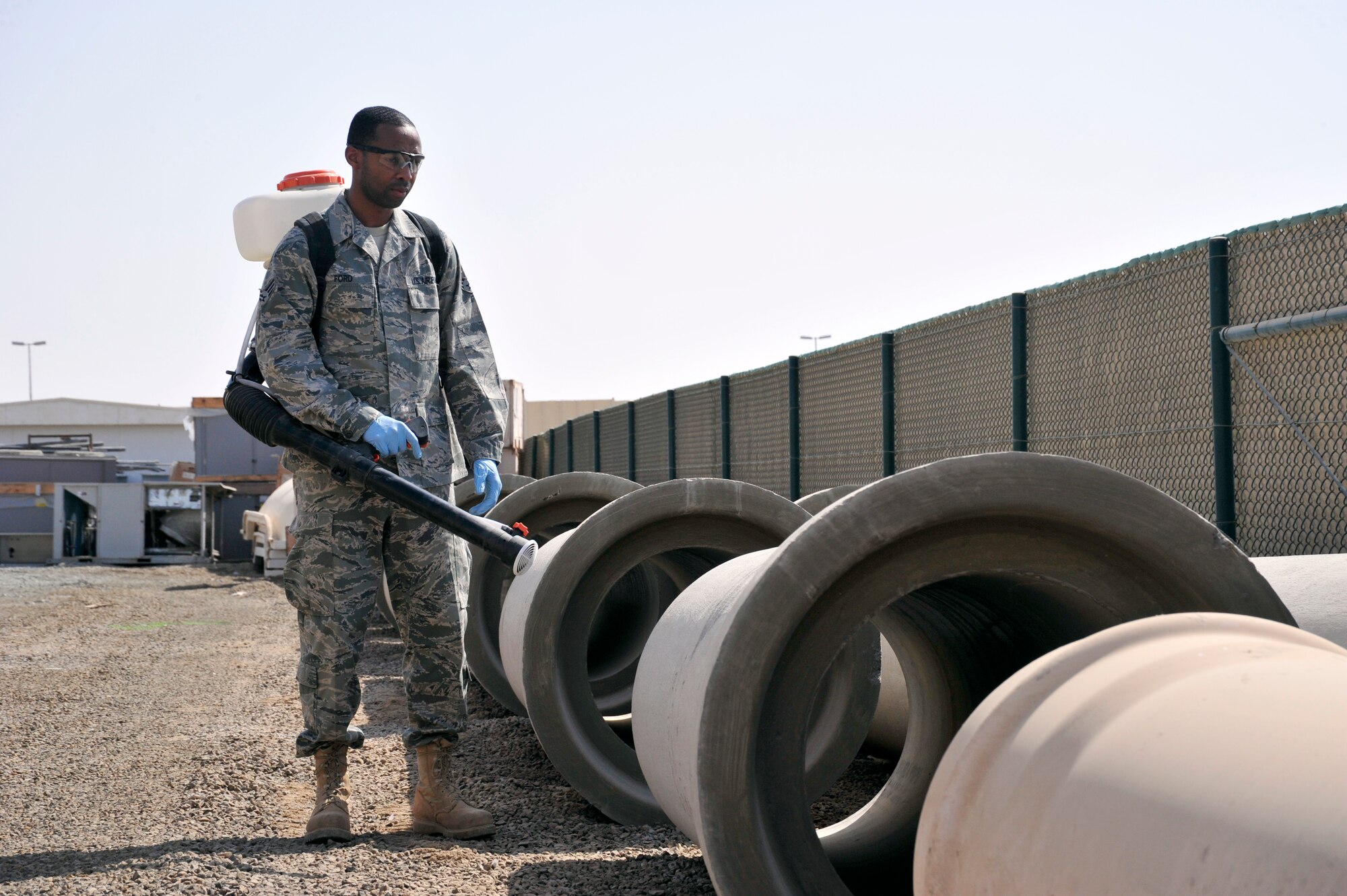 SOUTHWEST ASIA -Senior Airman Semorian Ford, 380th Expeditionary Civil Engineer Squadron, pest management journeyman, prepares to use a portable mist and dust blower here Sept. 25, 2009. Airman Ford is stationed at Scott Air Force Base, Ill., and grew up in Tyler, Texas. (U.S. Air Force photo/Tech. Sgt. Charles Larkin Sr)