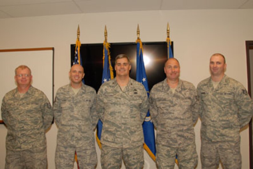 Technical Sgt. Mark Raut, Technical Sgt. Steven Sobus, Col. John M. Balbierer, 174FW Maintenance Group Commander, Technical Sgt. William Clochessy and Staff Sgt. Shawn Badman pose for a class photo on the 24th of September as part of the first graduating class of the Ground Control Station maintenance course held here at Hancock Field Air National Guard Base. (U. S. Air Force photo by Staff Sgt. Barbara Olney/RELEASED)