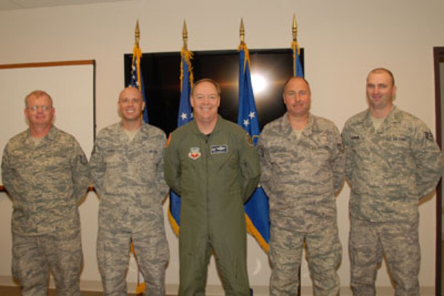 Technical Sgt. Mark Raut, Technical Sgt. Steven Sobus, Col. Kevin W. Bradley, 174FW Commander, Technical Sgt. William Clochessy and Staff Sgt. Shawn Badman pose for a class photo on the 24th of September as part of the first graduating class of the Ground Control Station maintenance course held here at Hancock Field Air National Guard Base. (U. S. Air Force photo by Staff Sgt. Barbara Olney/RELEASED)