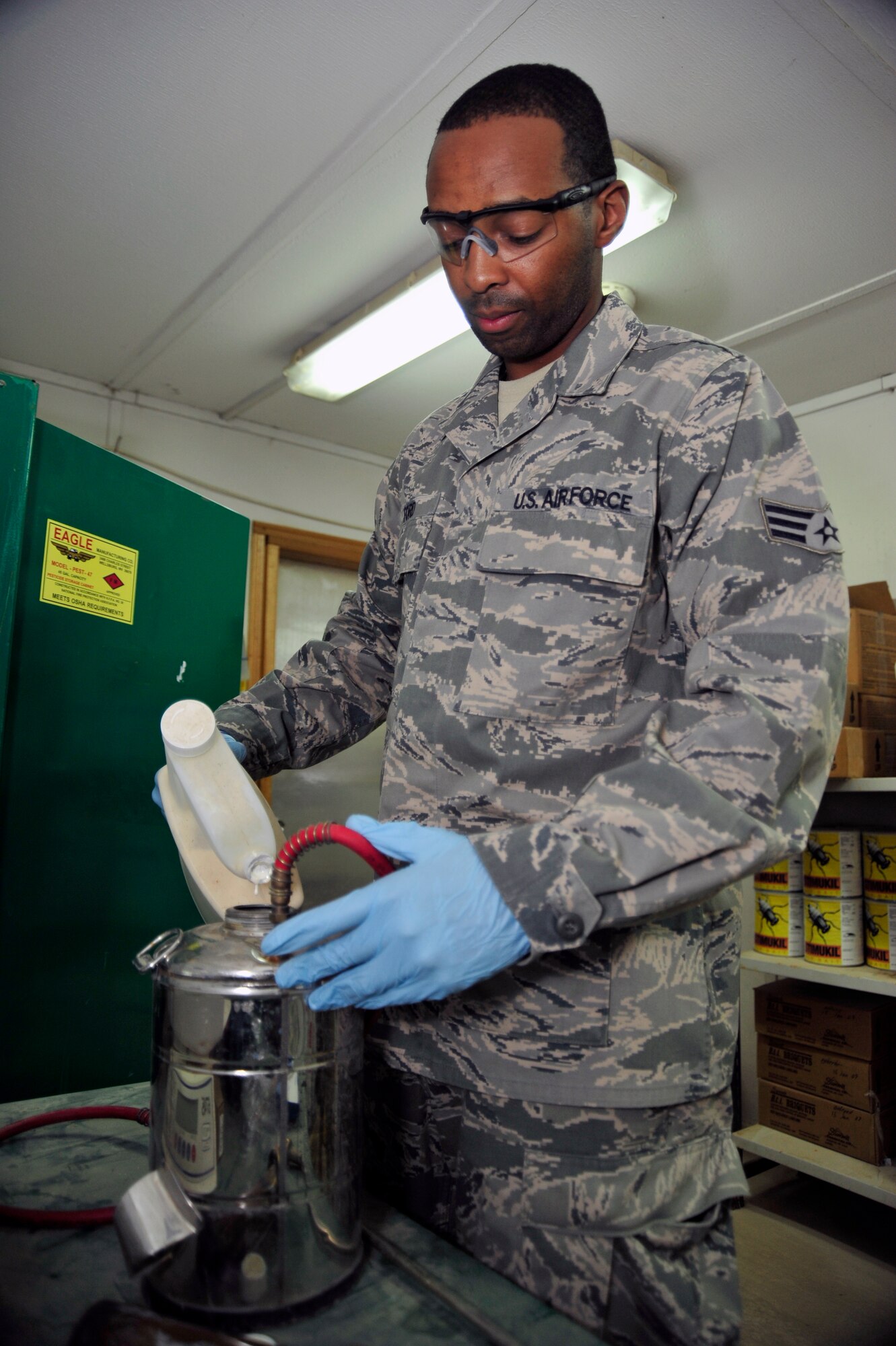 SOUTHWEST ASIA -Senior Airman Semorian Ford, 380th Expeditionary Civil Engineer Squadron, pest management journeyman, mixes a multi-use pesticide into a one-gallon sprayer here Sept. 25, 2009. Airman Ford is stationed at Scott Air Force Base, Ill., and grew up in Tyler, Texas. (U.S. Air Force photo/Tech. Sgt. Charles Larkin Sr)