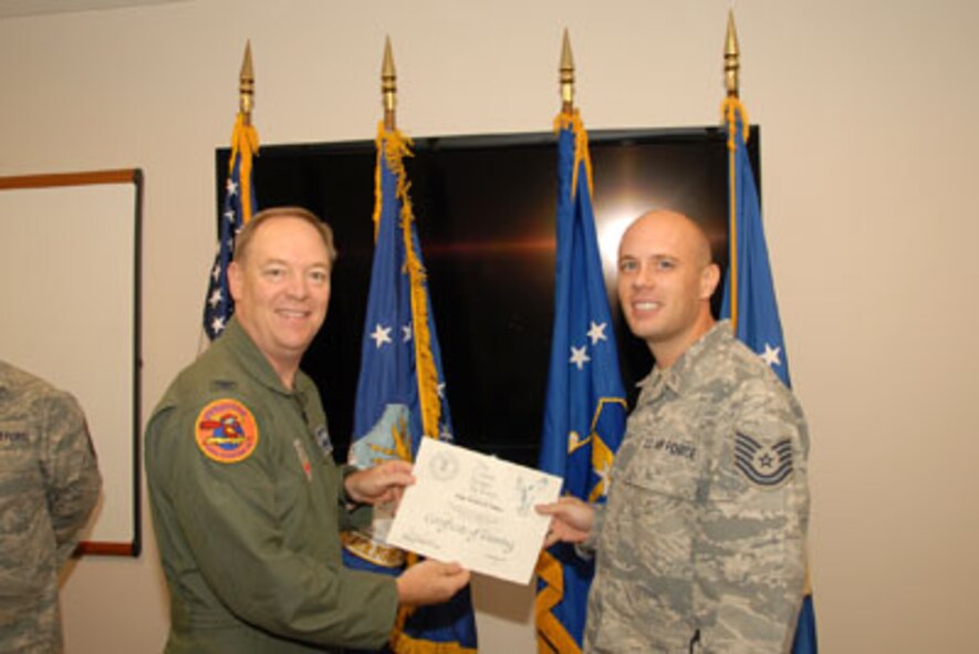 Col. Kevin W. Bradley, 174FW Commander presents Technical Sgt. Steven Sobus with his certificate on the 24th of September as part of the first graduating class of the Ground Control Station maintenance course held here at Hancock Field Air National Guard Base. (U. S. Air Force photo by Staff Sgt. Barbara Olney/RELEASED)