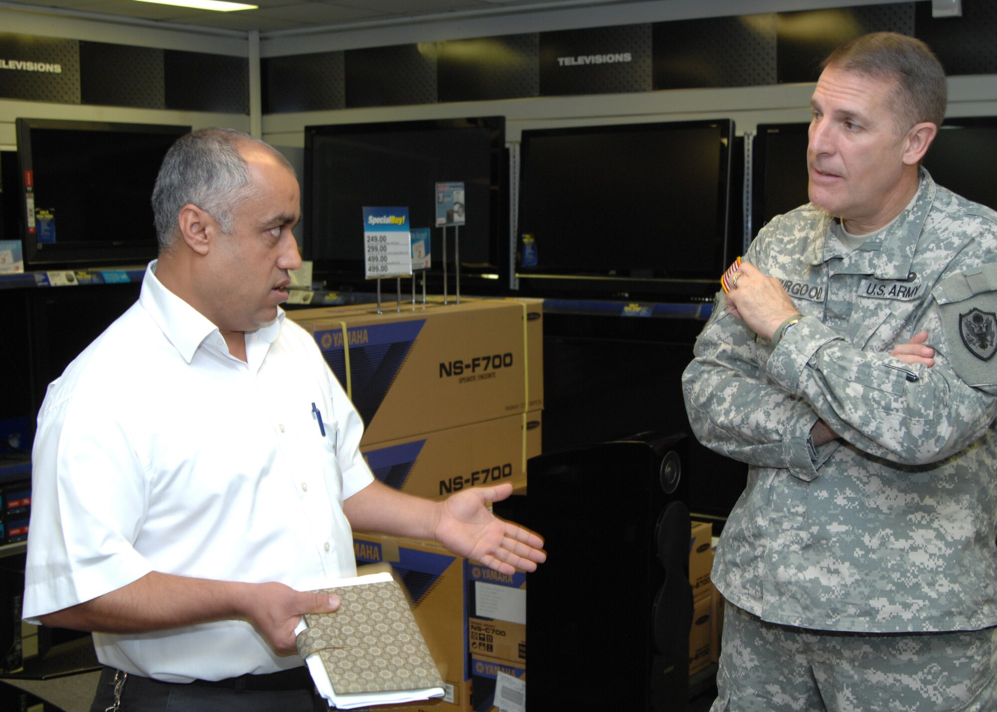 Mehmet Celik, hardlines manager, discusses the set-up and sales of the Base Exchange Powerzone to Maj. Gen. Keith Thurgood, Army and Air Force Exchange Service commander, Wednesday,  September 23, 2009 at Incirlik Air Base, Turkey.   General Thurgood’s visited Incirlik to meet the AAFES staff, learn base specific procedures and offer advice.  (U.S. Air Force photo/Staff Sgt. Lauren Padden)
