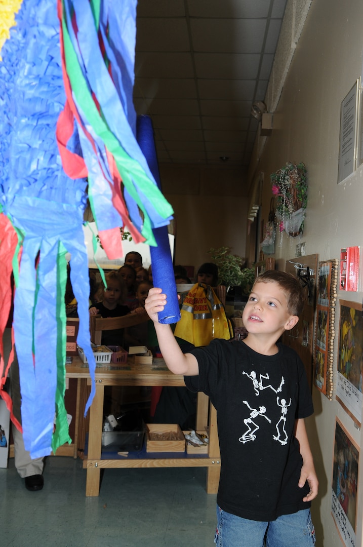 Tyler Stegen hits the piñata during the Hispanic Heritage Month piñata party at the Randolph Child Development Center Sept. 24.  (U.S. Air Force photo/Don Lindsey)