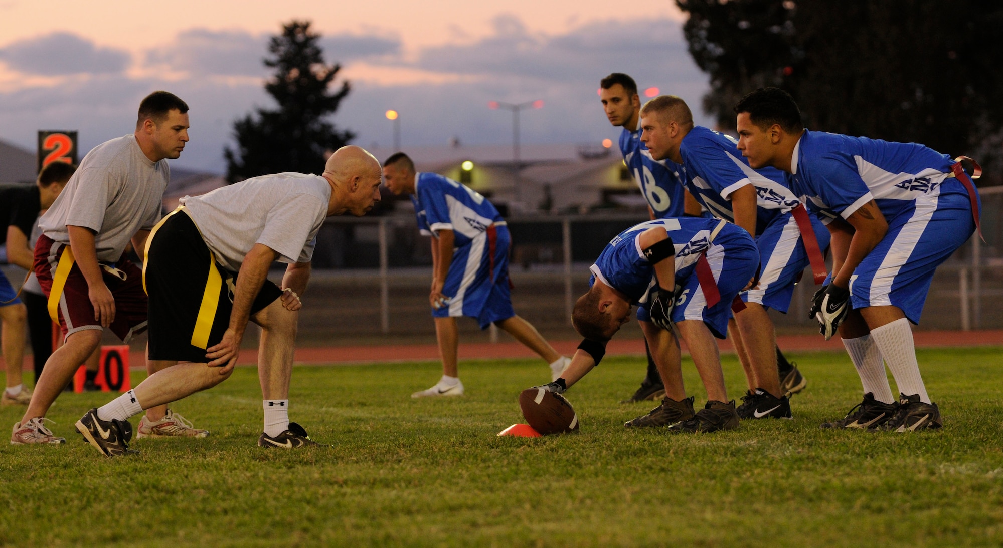 Airmen from the 39th Maintenance Squadron and the 728th Air Mobility Squadron wait for the snap Wednesday, Sept. 23, 2009, during an intramural flag football game at Incirlik Air Base, Turkey. There are eight squadrons competing in this year’s season with seven scheduled games before the playoffs. (U.S. Air Force photo/Airman 1st Class Amber Ashcraft)