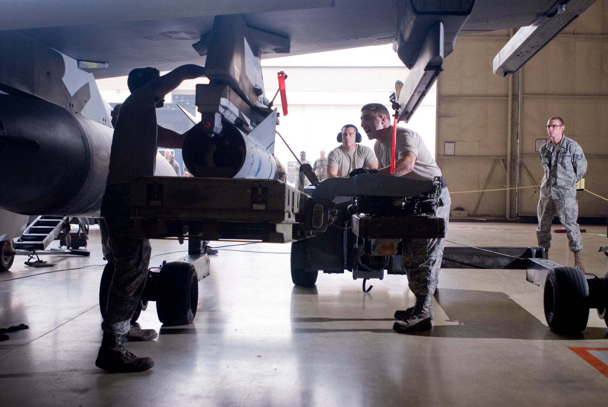 KUNSAN AIR BASE, Republic of Korea -- Senior Airman Kenneth Rankin, Airman 1st Class Nathan Brown and Staff Sgt. Darren Wittmann, 35th Aircraft Maintenance Unit, loads an AGM-65D Maverick onto an F-16 Fighting Falcon during Kunsan's monthly weapons load competition Sept. 25. The 389th Aircraft Maintenance Unit won over the 35th AMU and the 80th Aircraft Maintenance Unit.  (U.S. Air Force photo/ Senior Airman Jonathan Steffen)