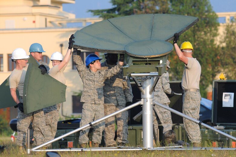 Airmen from the 1st Combat Communications Squadron set up a USC-60 satellite Sept. 22, 2009 at Aviano Air Base, Italy, during a weeklong training exercise. The training is in preparation for the largest transformation in the history of Air Force communications, which transitions 16 communications Air Force Specialty Codes into 11 new cyberspace support specialties.  It takes a three-person team about an hour to set up the approximate 400-pound, 30-piece, satellite which comes in 12 containers when broken down.  (U.S. Air Force photo/Staff Sgt. Patrick Dixon)