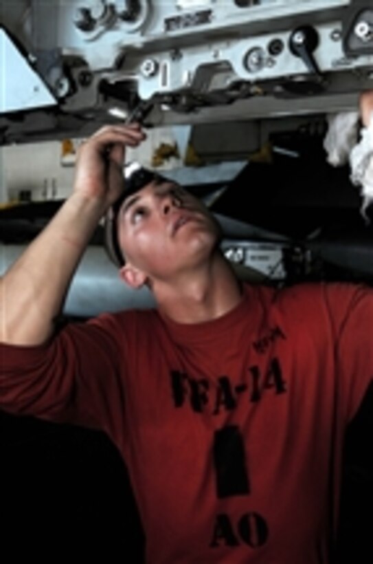 U.S. Navy Airman Seth Houston, assigned to Strike Fighter Squadron 14, inspects and cleans a BRU-32 bomb rack in the hangar bay of the aircraft carrier USS Nimitz (CVN 68) in the Bay of Bengal on Sept. 14, 2009.  The Nimitz and embarked Carrier Air Wing 11 are deployed to the U.S. 5th Fleet area of responsibility.  