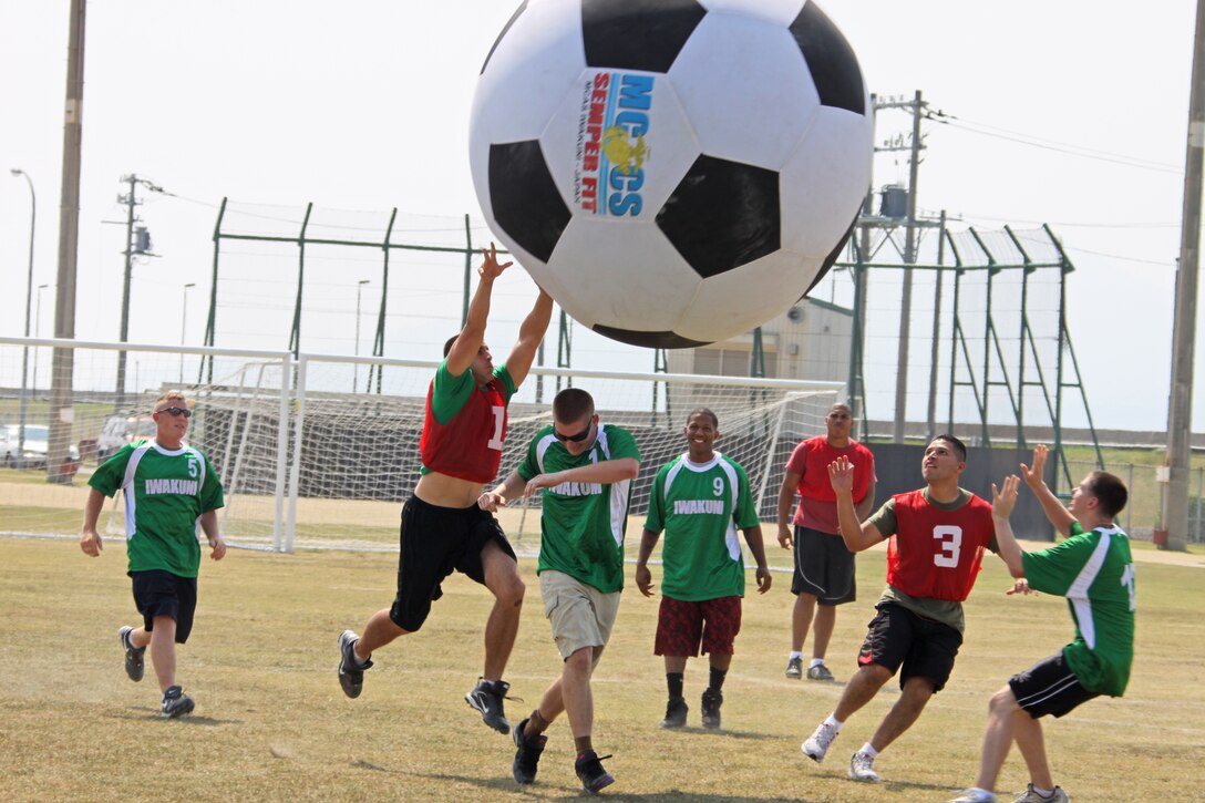 Marine Wing Support Squadron 171 offense players pass the ball over the competition during the 2009 Commander’s Cup Challenge Earth Ball held at the Penny Lake soccer fields here Sept. 25. Earth Ball was the final::r::::n::challenge before the Gladiators Cup, which is the final event to conclude the 2009 Commander’s Cup. MWSS-171 went undefeated in the single-elimination tournament to win with a 3-0 record and the first place trophy.
